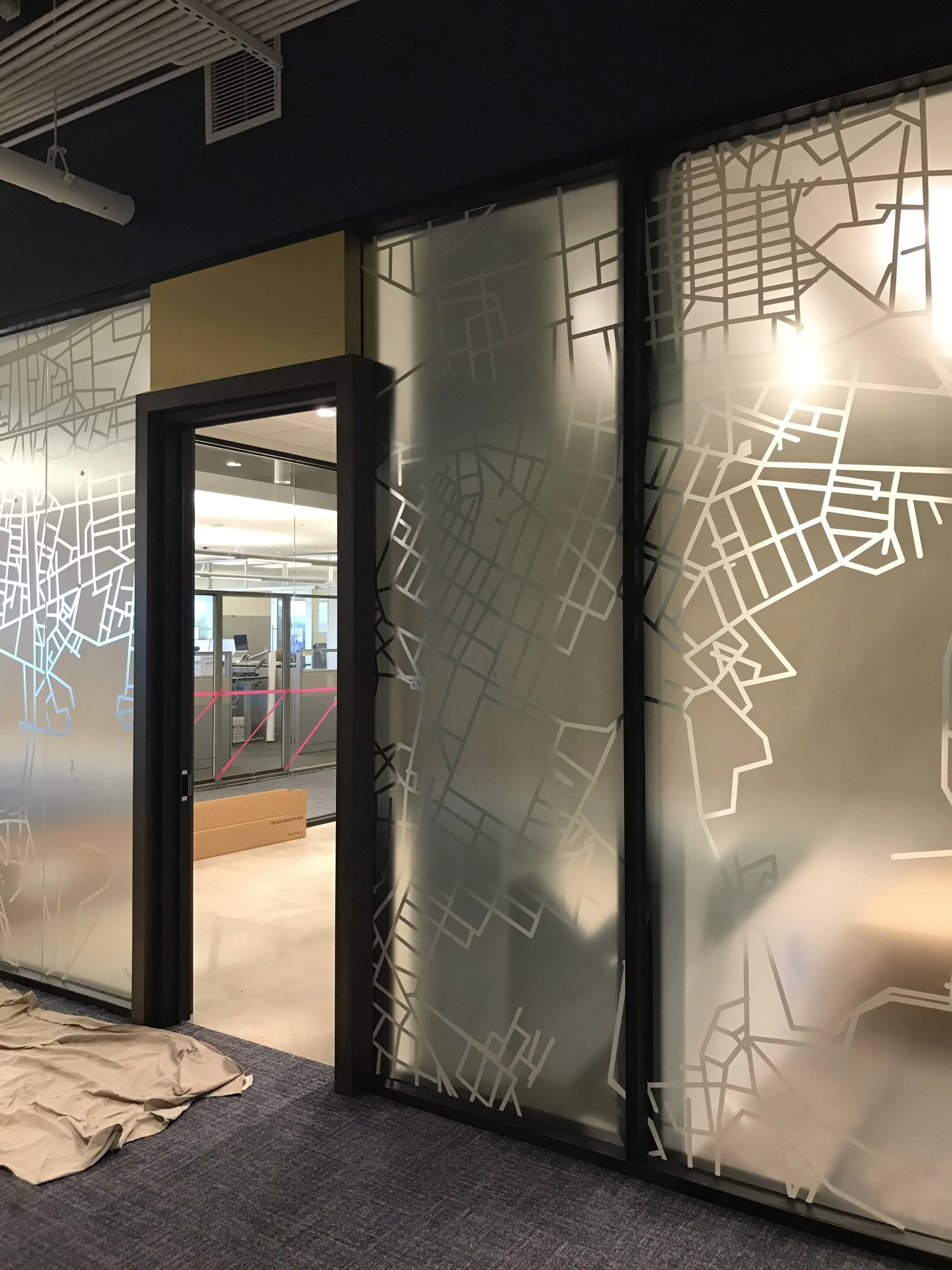 Custom decorative window film with abstract pattern on interior glass partitions