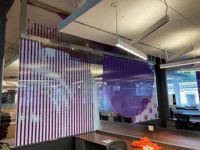Completed glass film installation at eBay New York office featuring custom purple environmental graphics on workplace conference room glazing by JP Digital