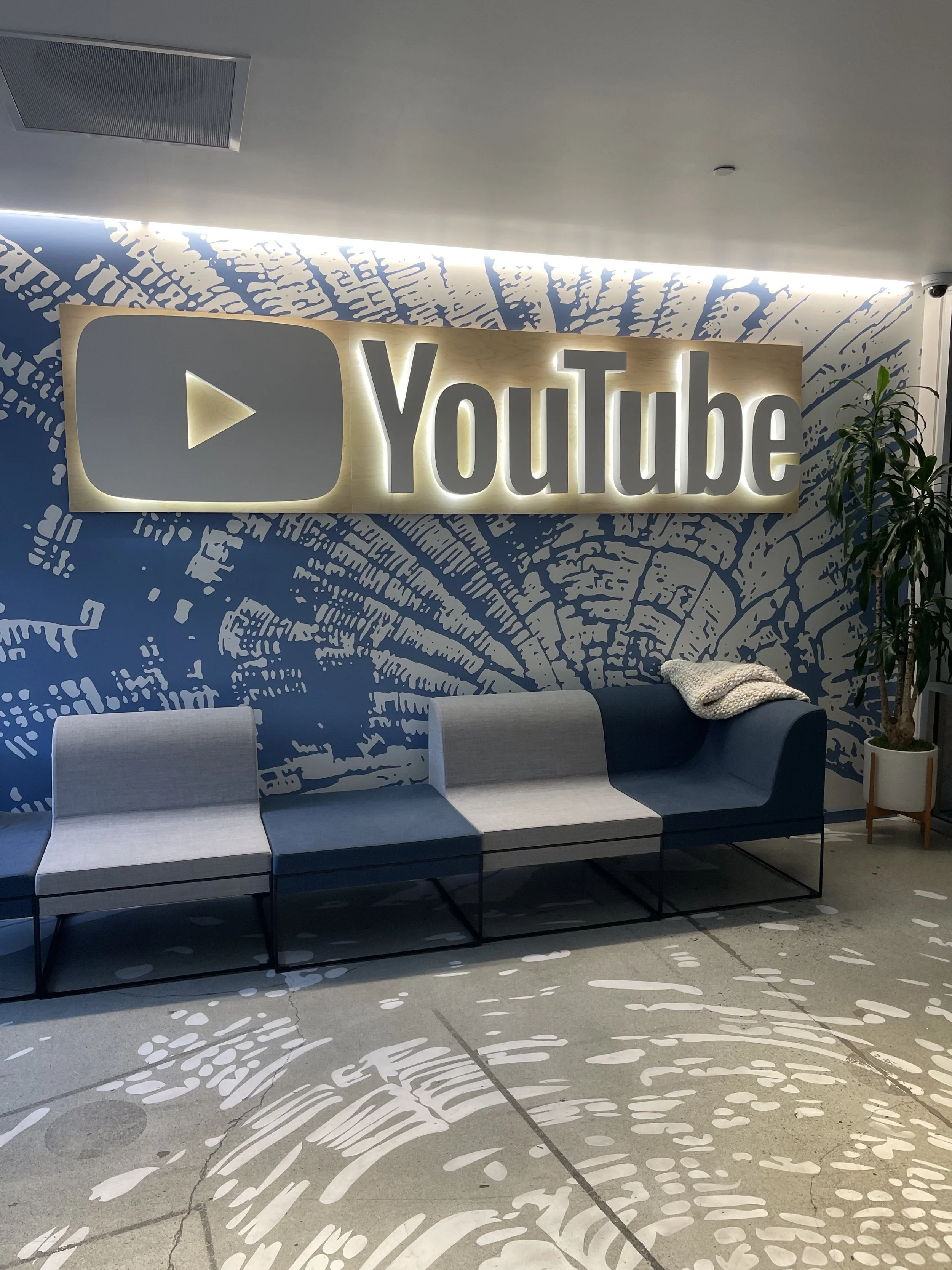 Dimensional YouTube lobby signage installed on branded feature wall to create a bold corporate reception experience