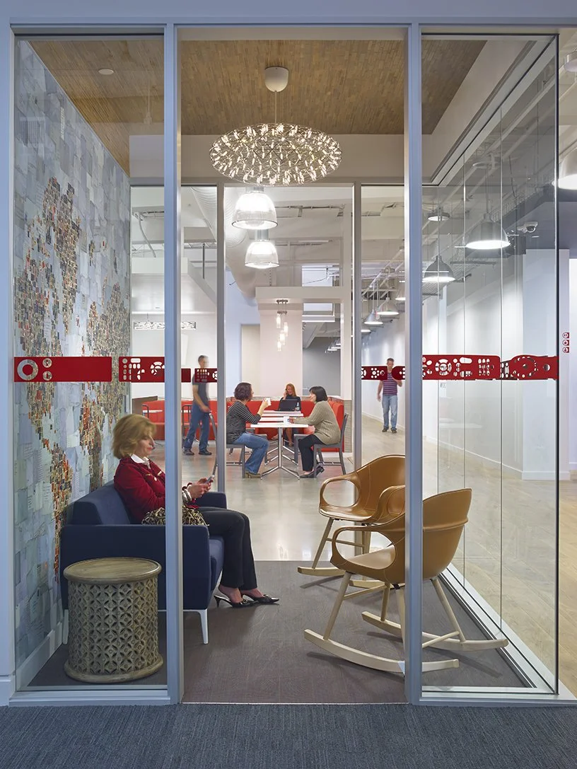 Office glass walls with branded privacy window film graphics and company messaging