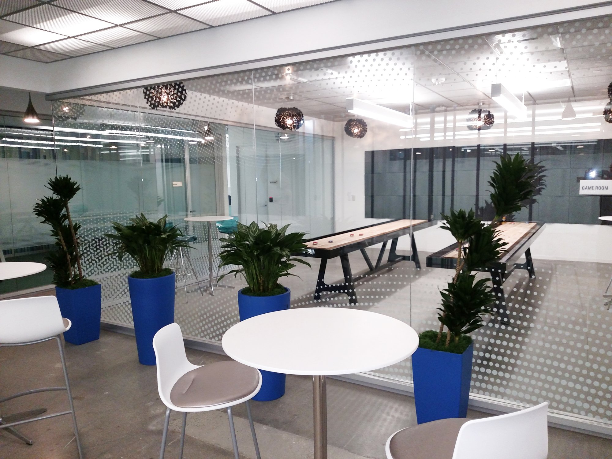 Dotted privacy window film installed on glass conference room walls in a modern commercial office, providing privacy while maintaining natural light.