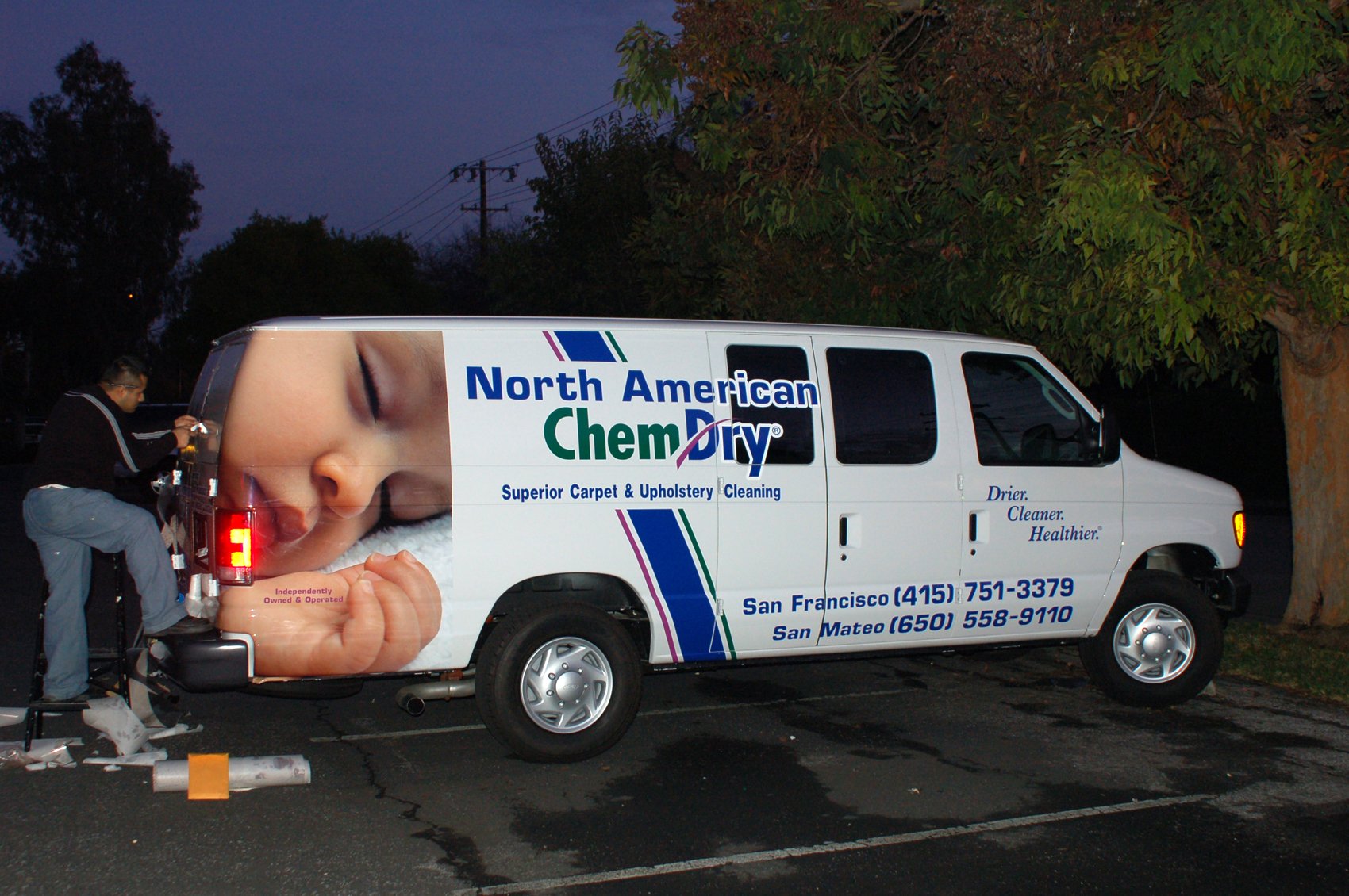 Healthcare service van with partial vehicle wrap and branded graphics for professional fleet identification.