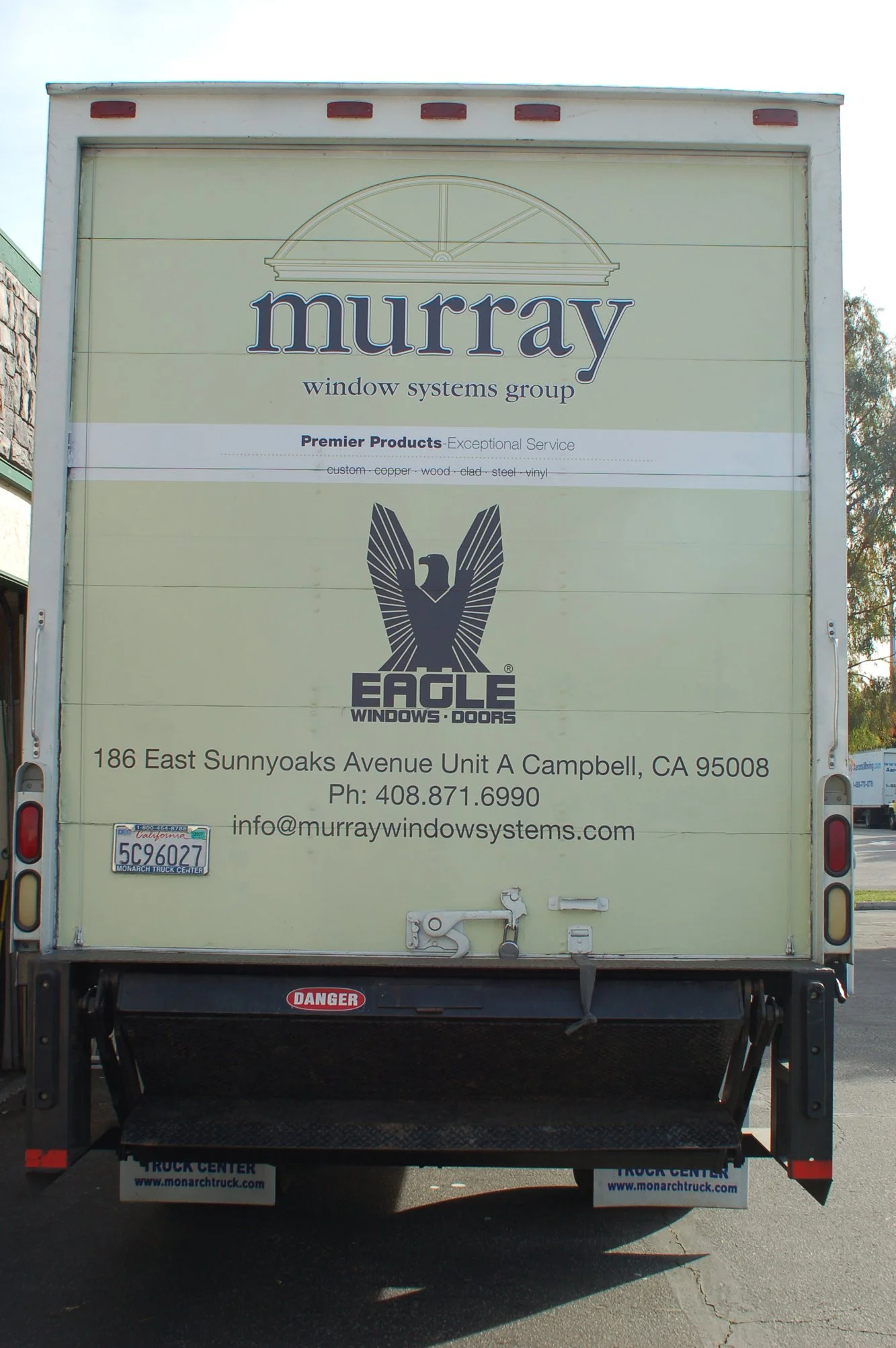 Rear view of delivery truck with custom fleet wrap and company identification designed for brand recognition on the road.