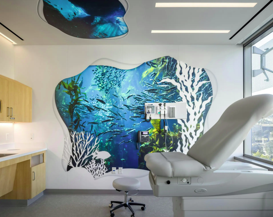 UCSF Stad Center pediatric space featuring immersive underwater wall graphics and integrated seating designed to create a calming healing environment.