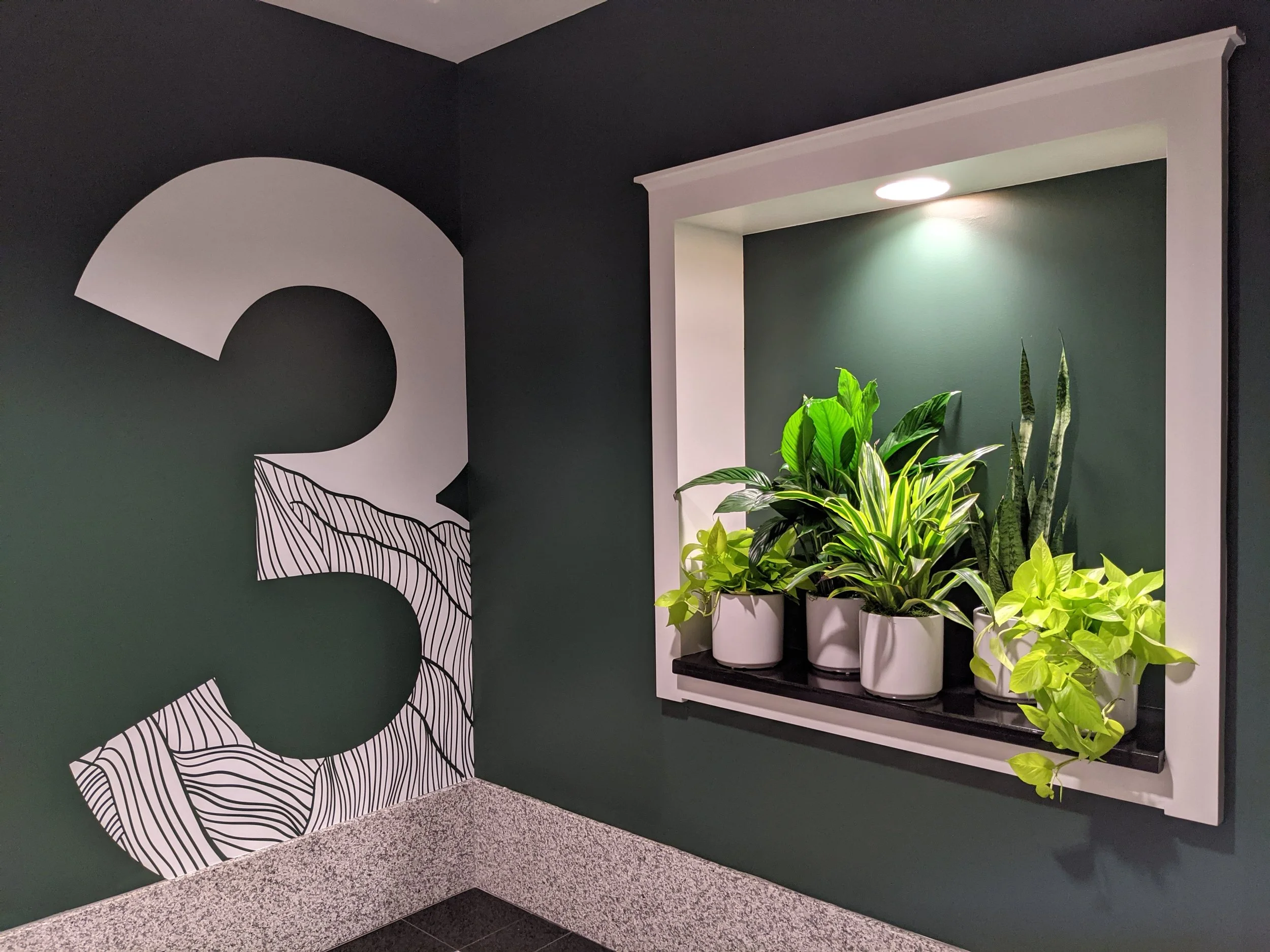 Installed dimensional lobby signage at Google Santa Cruz featuring custom fabricated lettering and integrated environmental graphics for workplace branding.