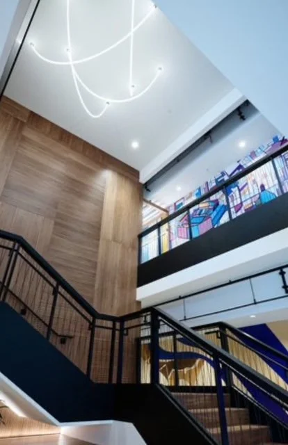Interior stairwell at the KPMG San Jose office featuring custom environmental graphics and architectural wall finishes installed by JP Digital.