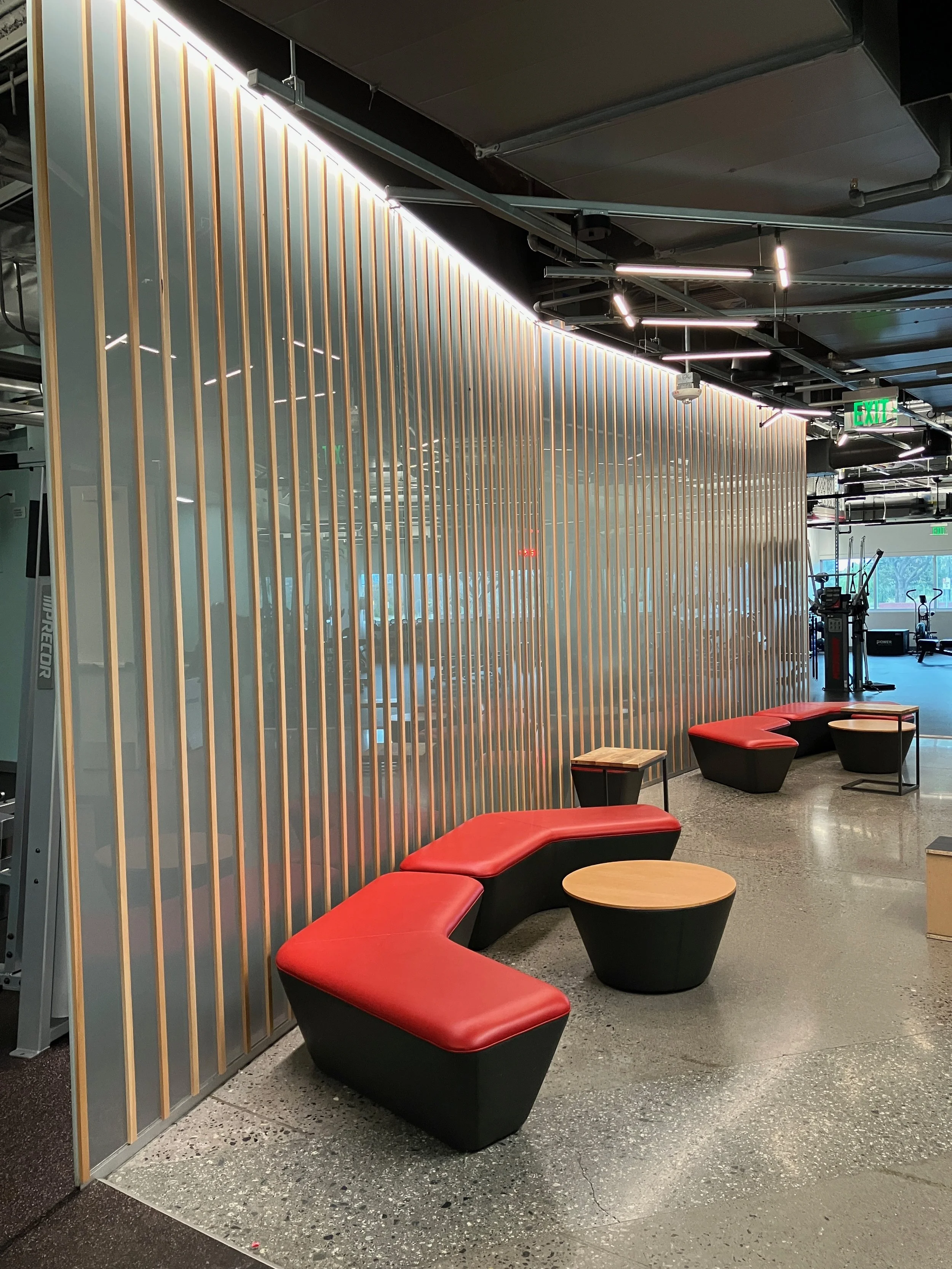 Decorative wood slat wall feature with integrated seating in corporate lobby area