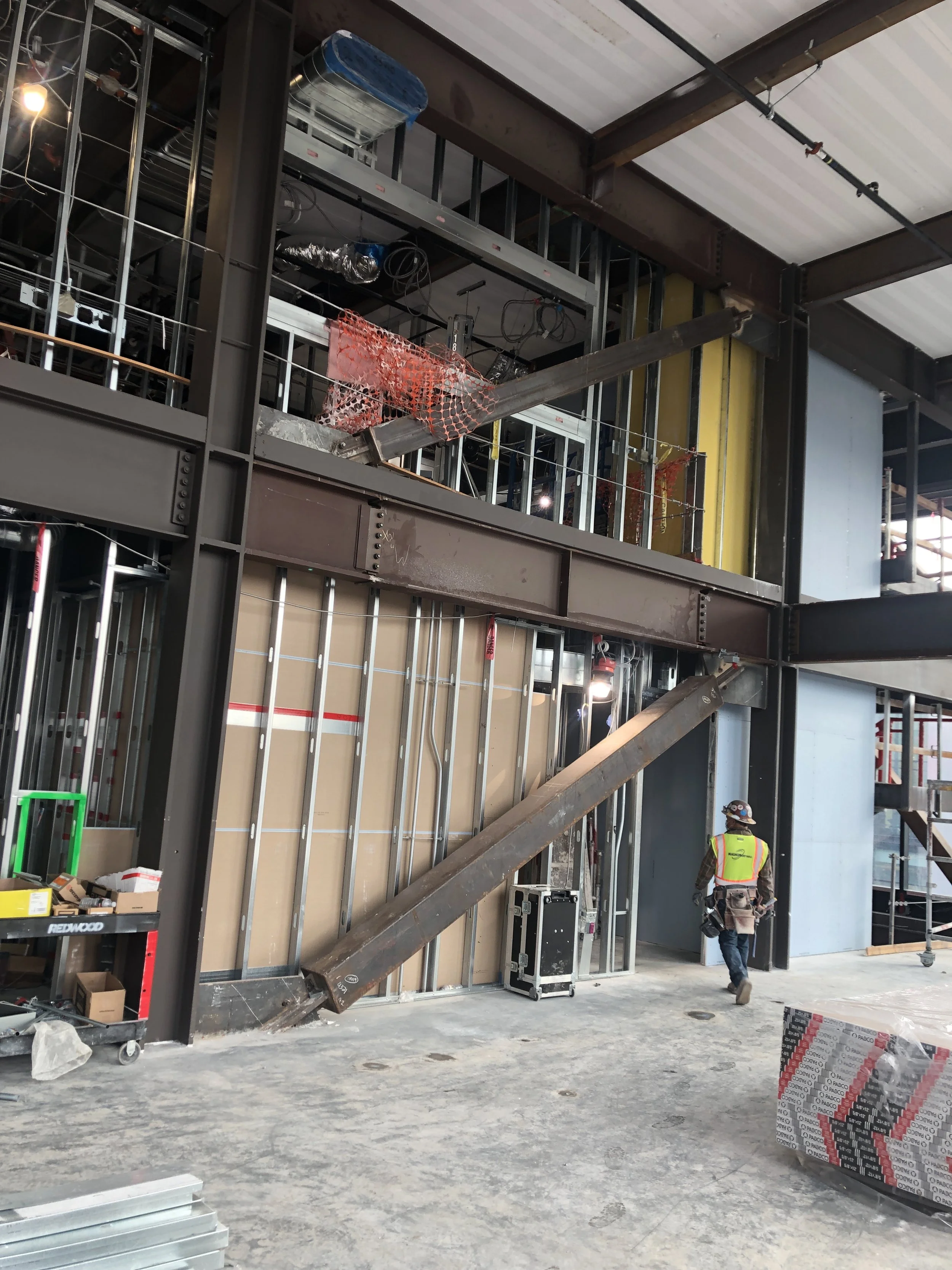 Pre-construction commercial interior showing wall preparation and site conditions prior to custom environmental graphics installation