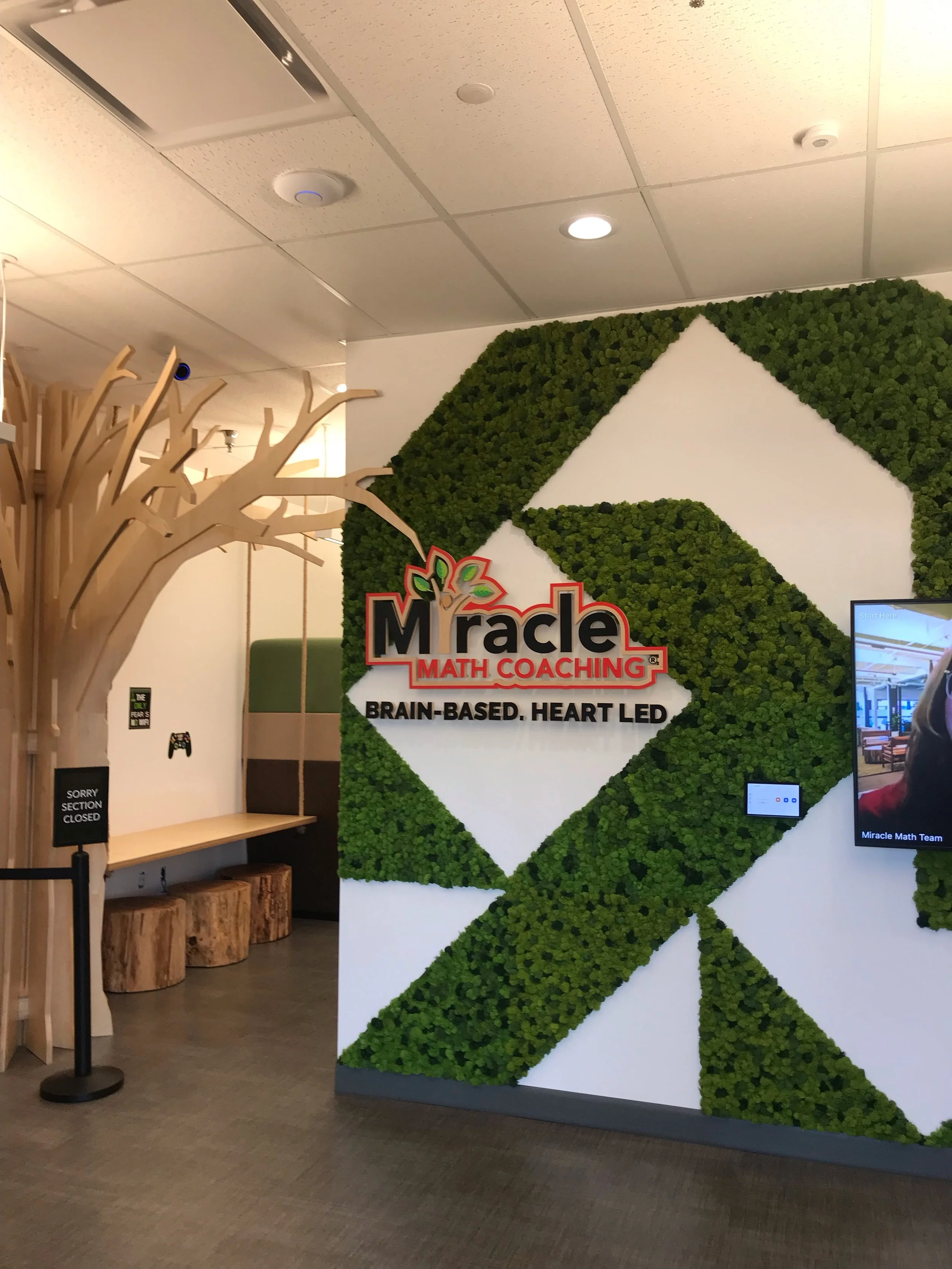 Custom environmental graphics and dimensional logo creating a branded feature wall 