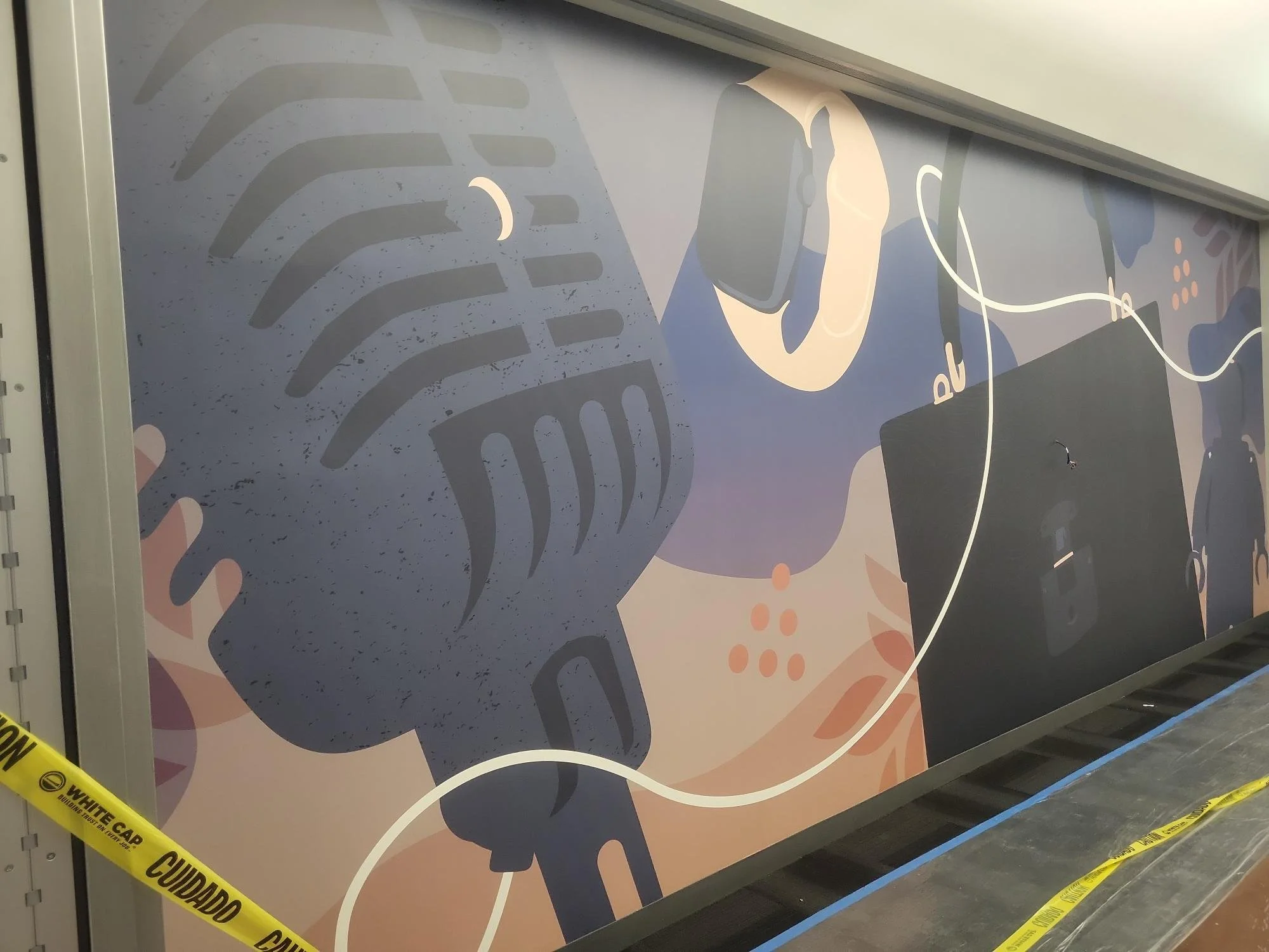 eBay Austin wallcovering installation in progress showing large-format custom graphics being applied in elevator lobby area.