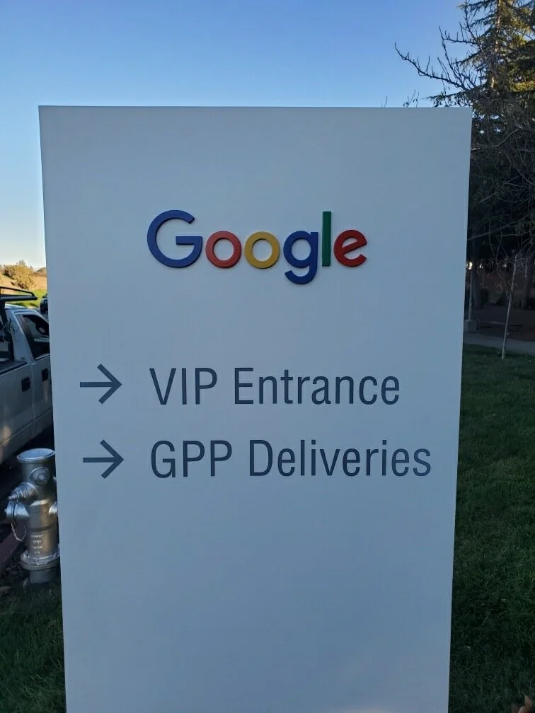 Exterior wayfinding signage for Google directing visitors to entrance and delivery locations