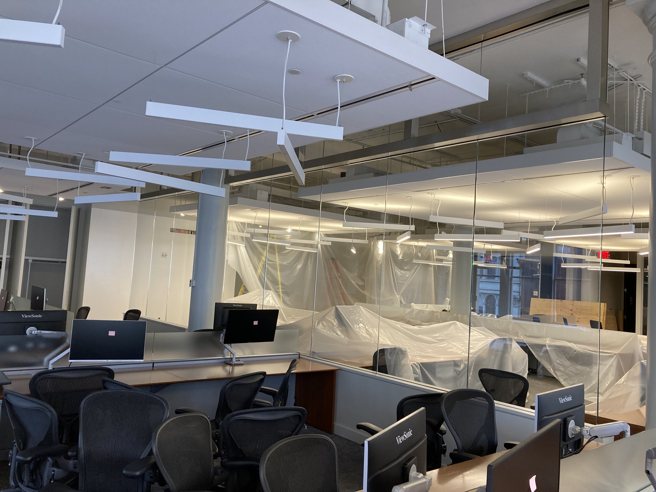Before installation of environmental graphics at eBay New York office showing open workspace and conference room glass prior to custom glass film application