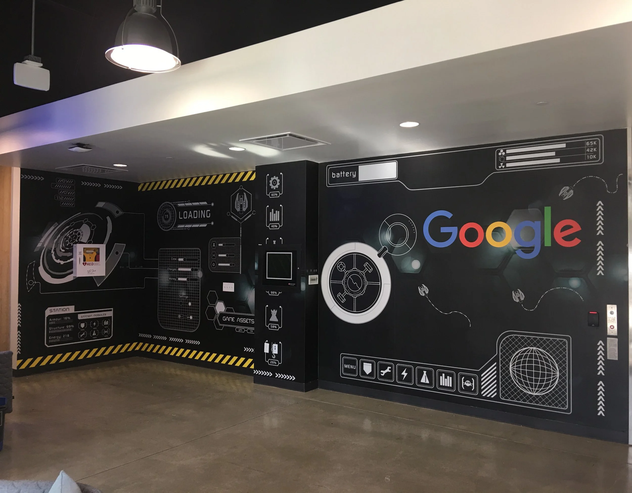 Branded environmental graphics wall featuring company messaging and graphics in a corporate office.