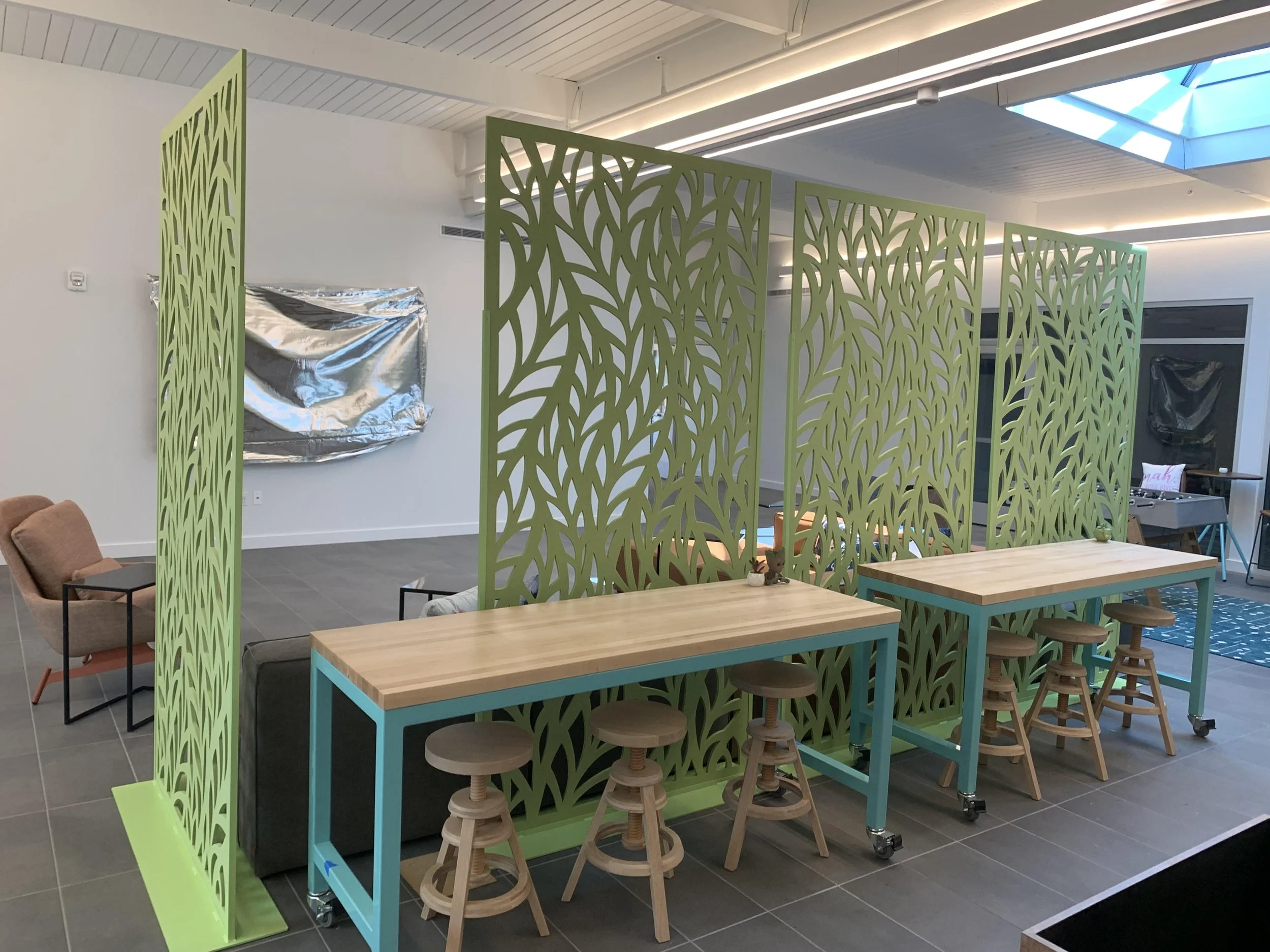 Decorative acoustic screen providing visual privacy and noise reduction in collaborative workspace
