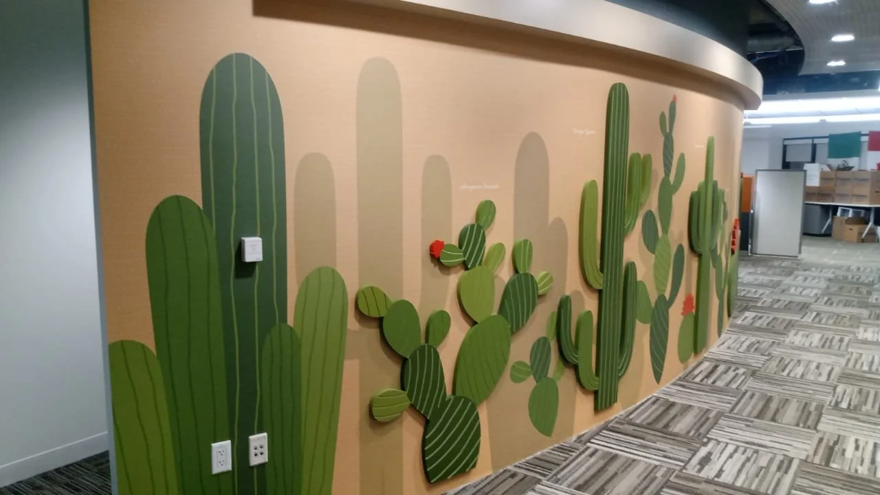 Installed cactus-themed wallcovering with dimensional Sintra elements in Amazon SJC3 office corridor, Cupertino, California, fabricated and installed by JP Digital.