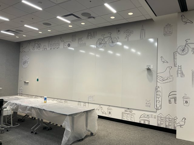 Wide-angle view of Pinterest San Francisco workspace with large-scale environmental graphics and integrated interior branding installed by JP Digital.