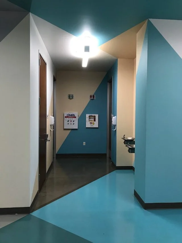 Directional floor graphics installed in healthcare corridor to guide circulation and improve wayfinding