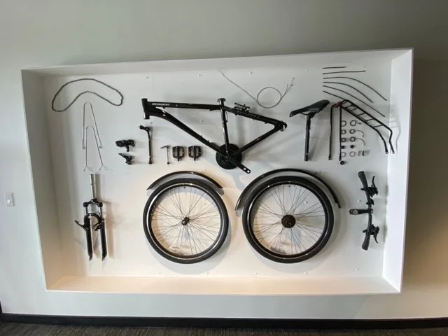 Custom dimensional wall display featuring mounted bicycles and graphic elements to create a unique branded feature wall.