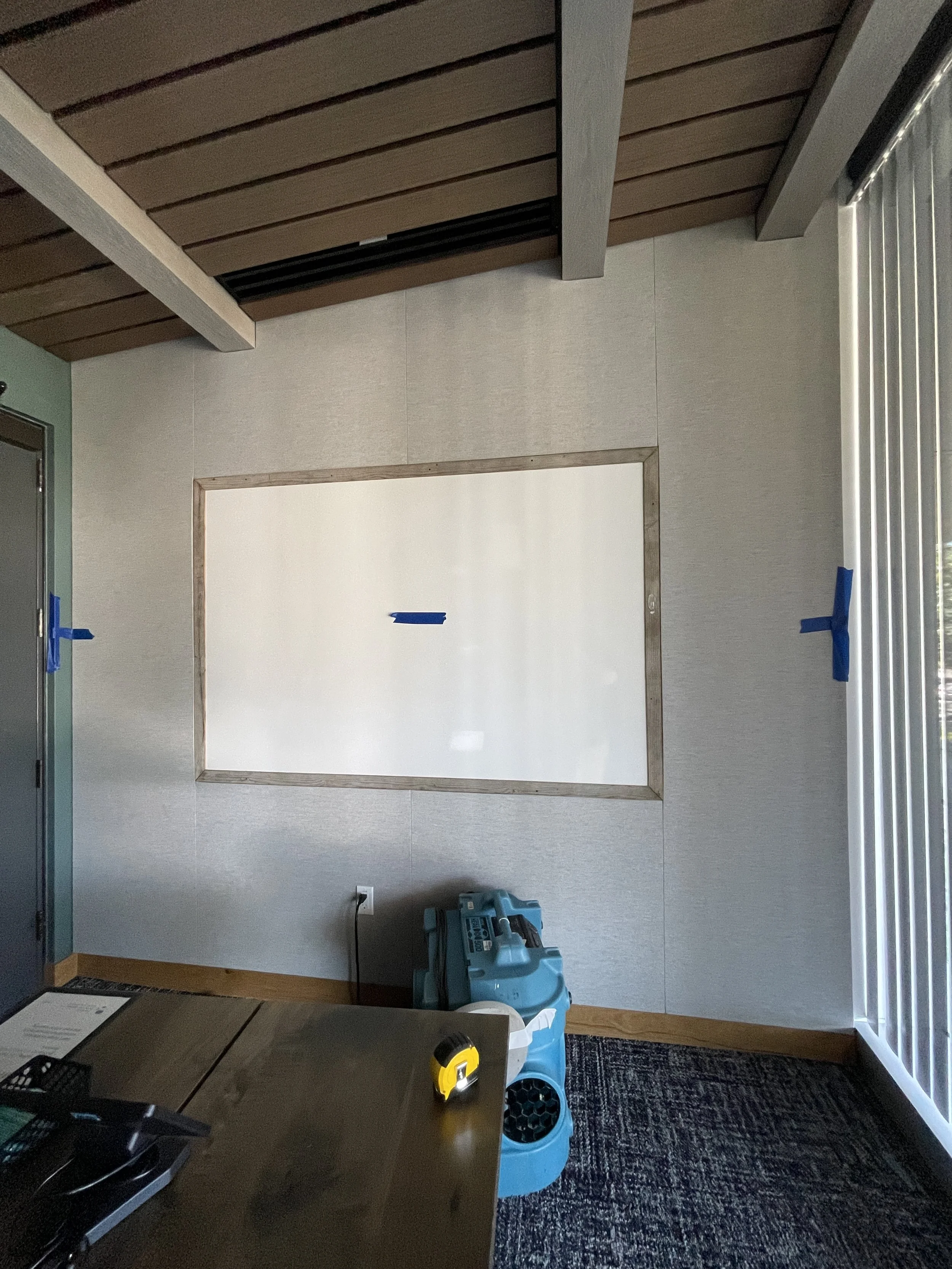 Fabric-wrapped acoustic wall panels installed to absorb sound in commercial interior