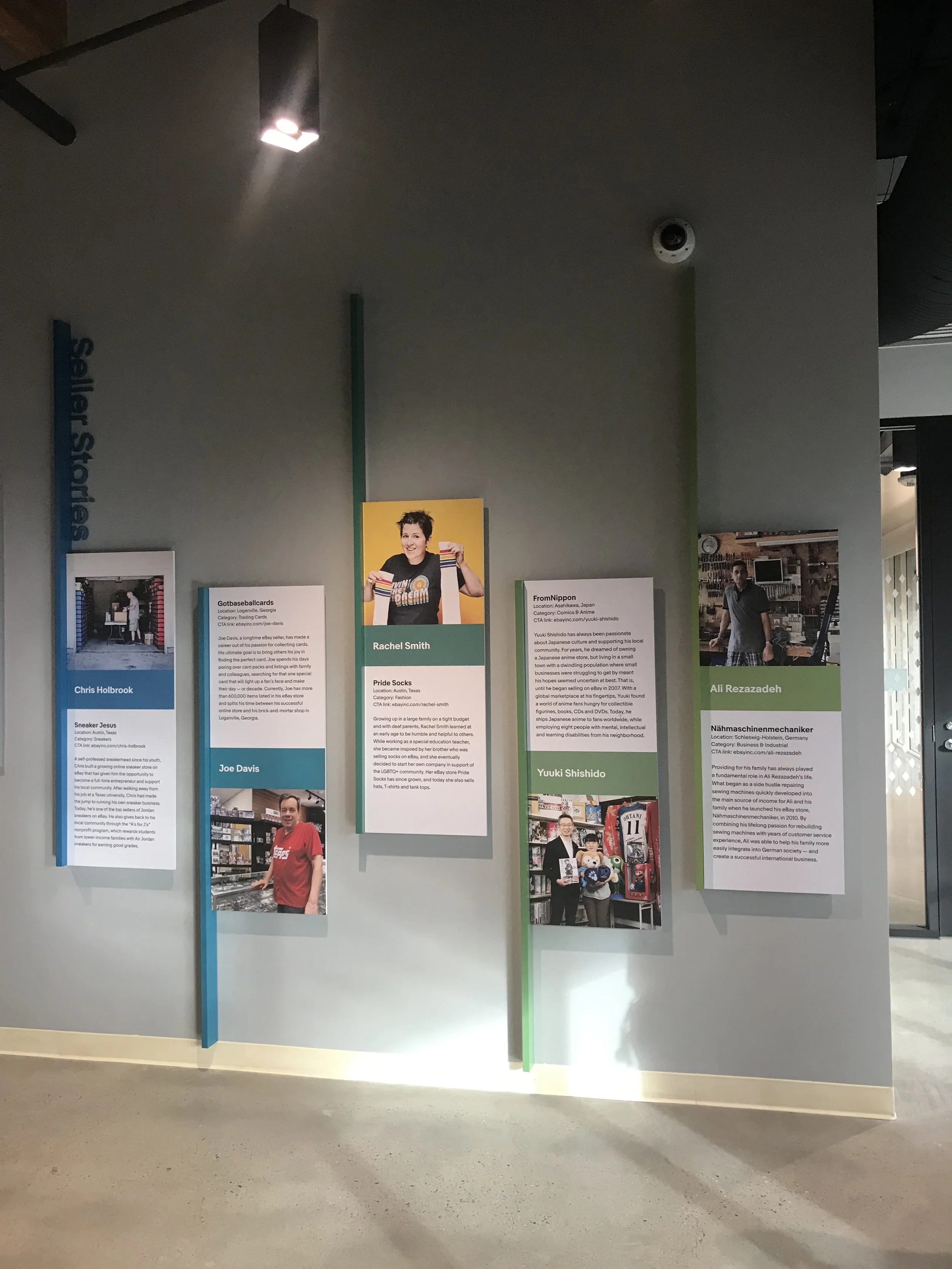 Custom vertical feature panels combining graphics, dimensional elements, and integrated lighting to create an engaging experiential display.