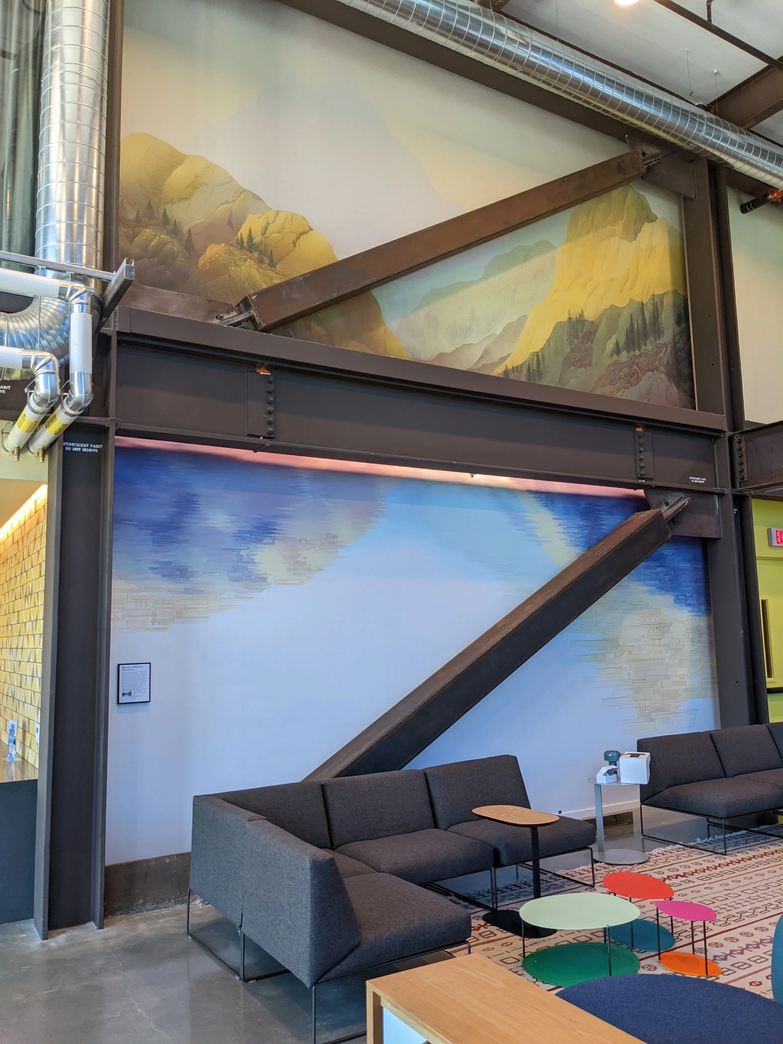 Large-scale landscape wall mural installation in a modern office lounge featuring custom commercial wallcovering and environmental graphics