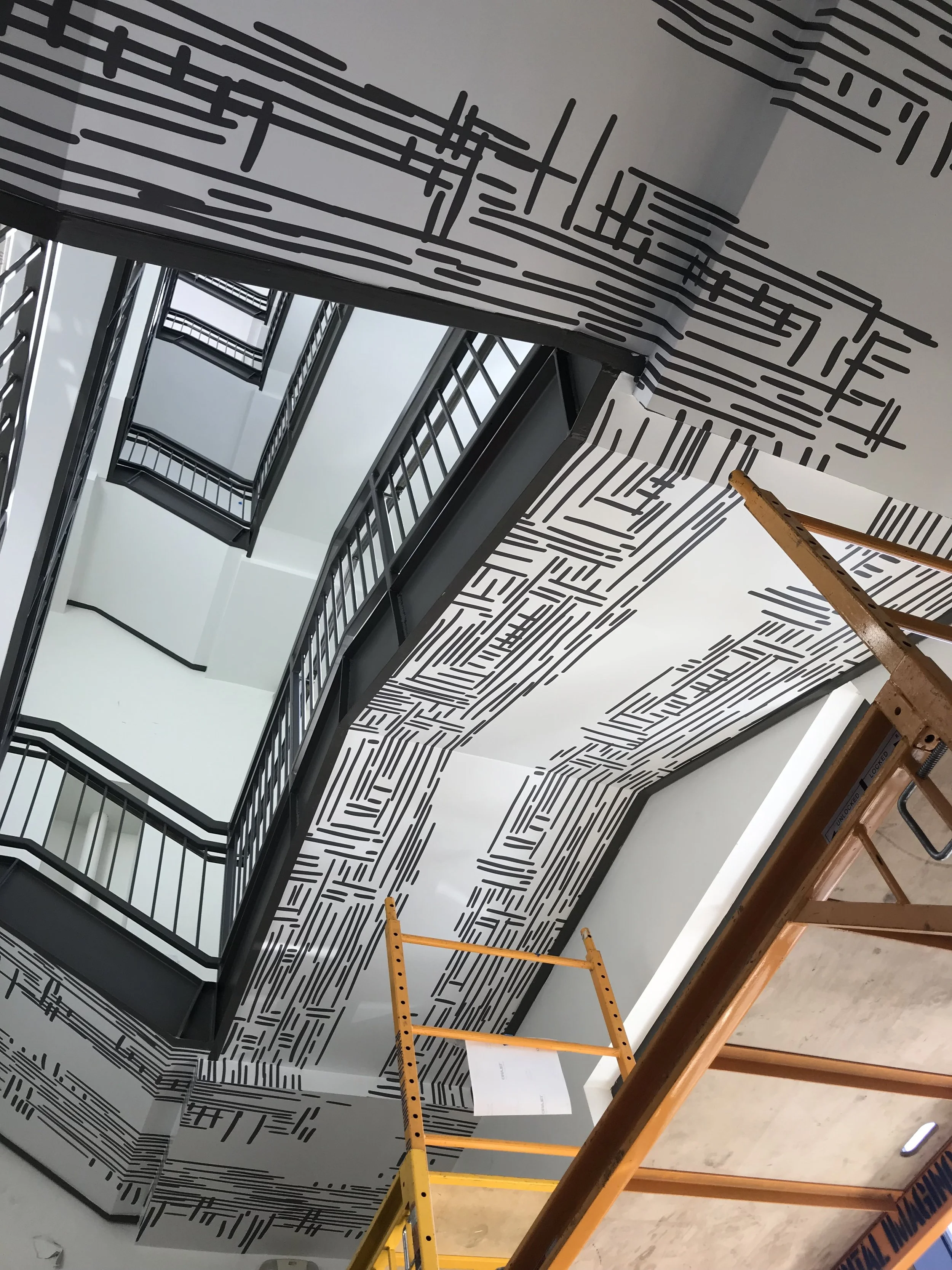 Finished environmental graphics at a stair landing in Google Santa Cruz, highlighting seamless large-format wallcovering and precise color alignment.