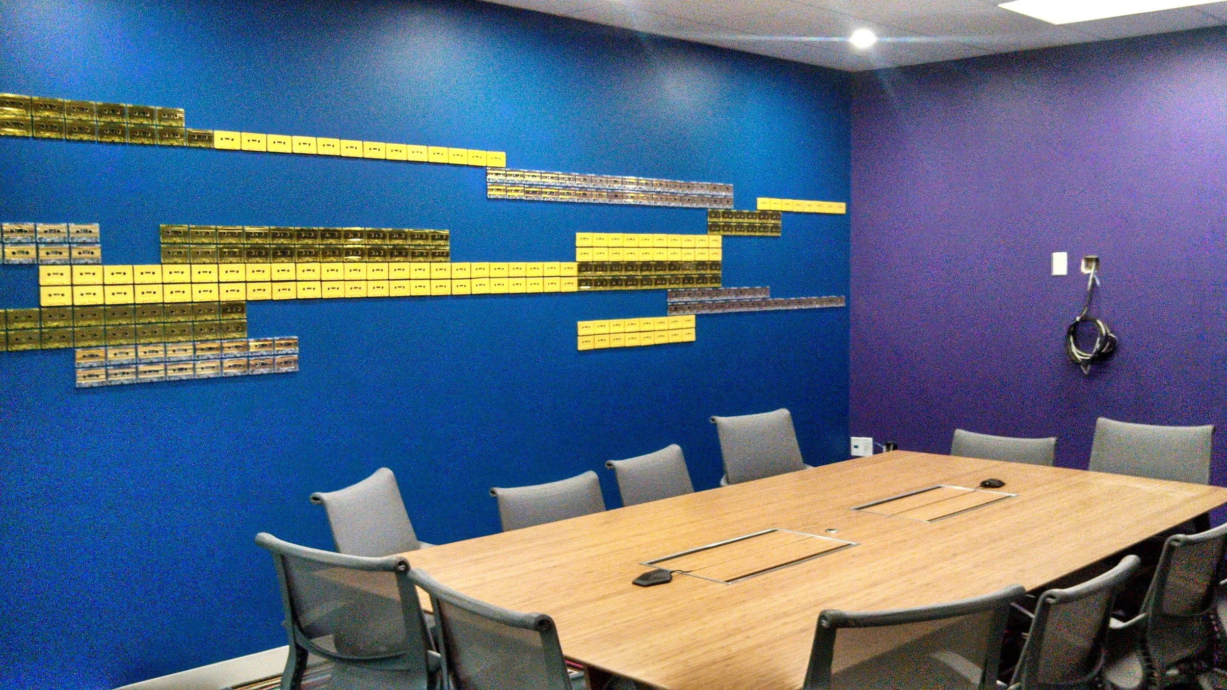 Abstract textured wallcovering with dimensional design installed in a conference room for a bold commercial feature wall.