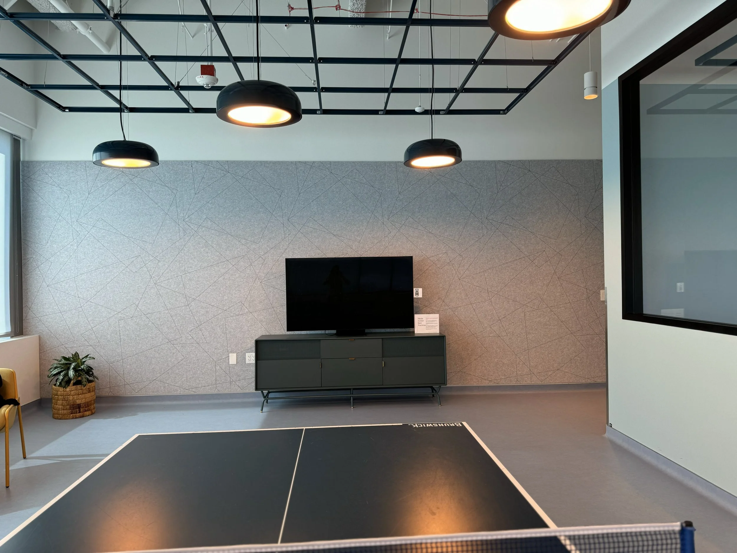 Modern collaboration area with branded wall graphics that support workplace culture and functional space design.