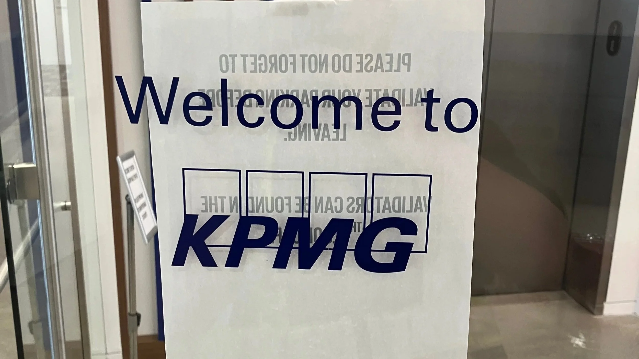Welcome to KPMG vinyl lettering applied to glass entry door for branded office reception at the KPMG San Jose location.