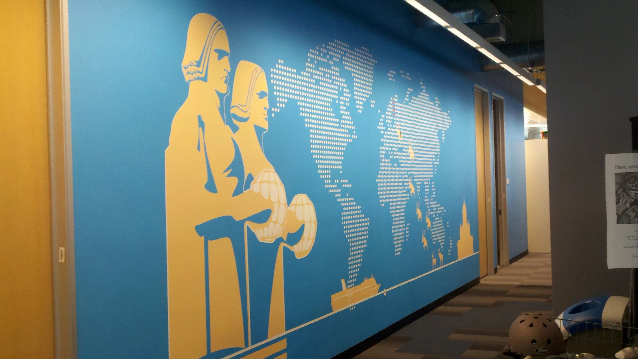 Custom illustrated mural wallcovering showcasing company history or storytelling in a corporate space.