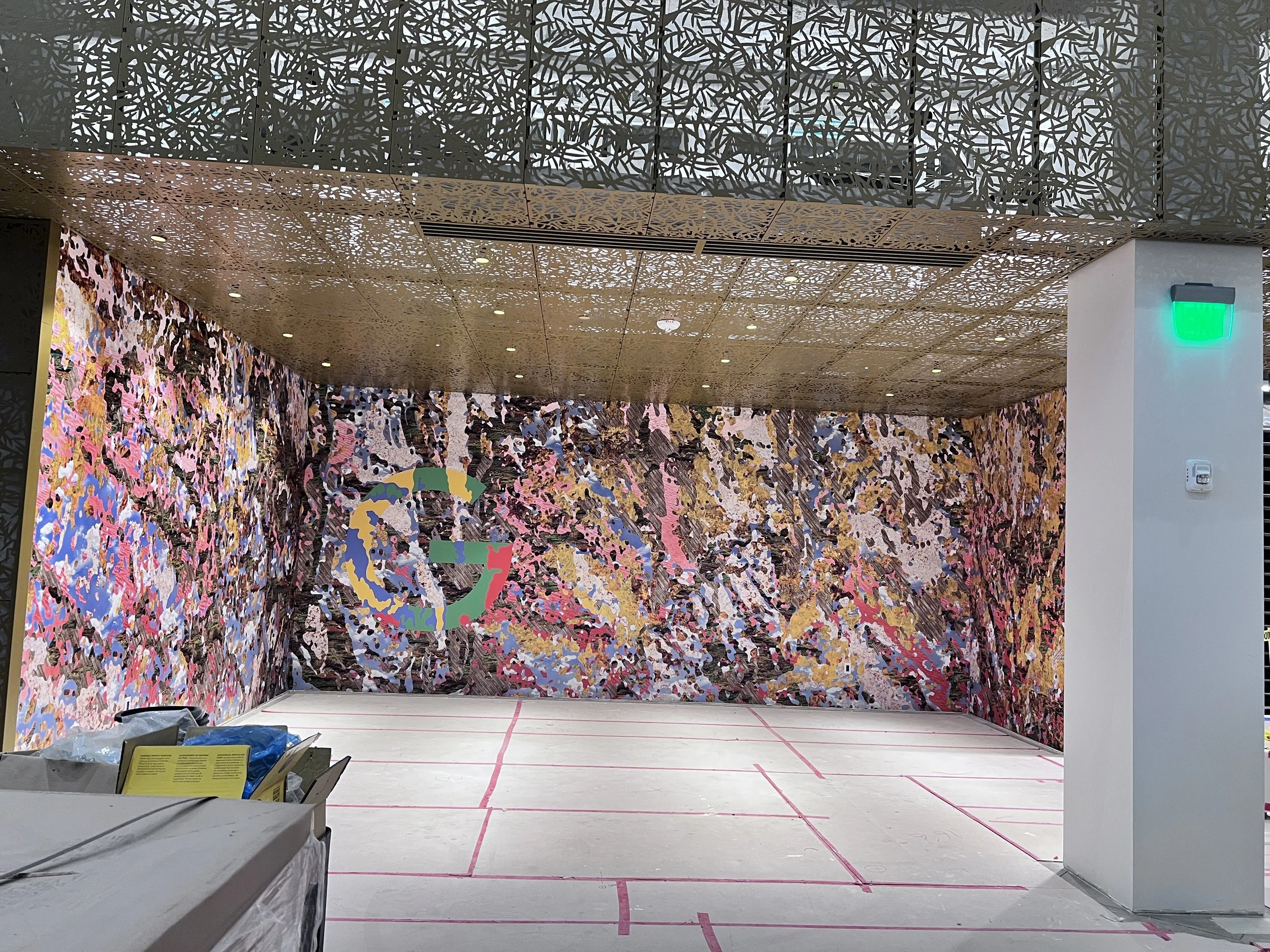 Floor-to-ceiling abstract color mural creating a vibrant environmental graphic feature wall.