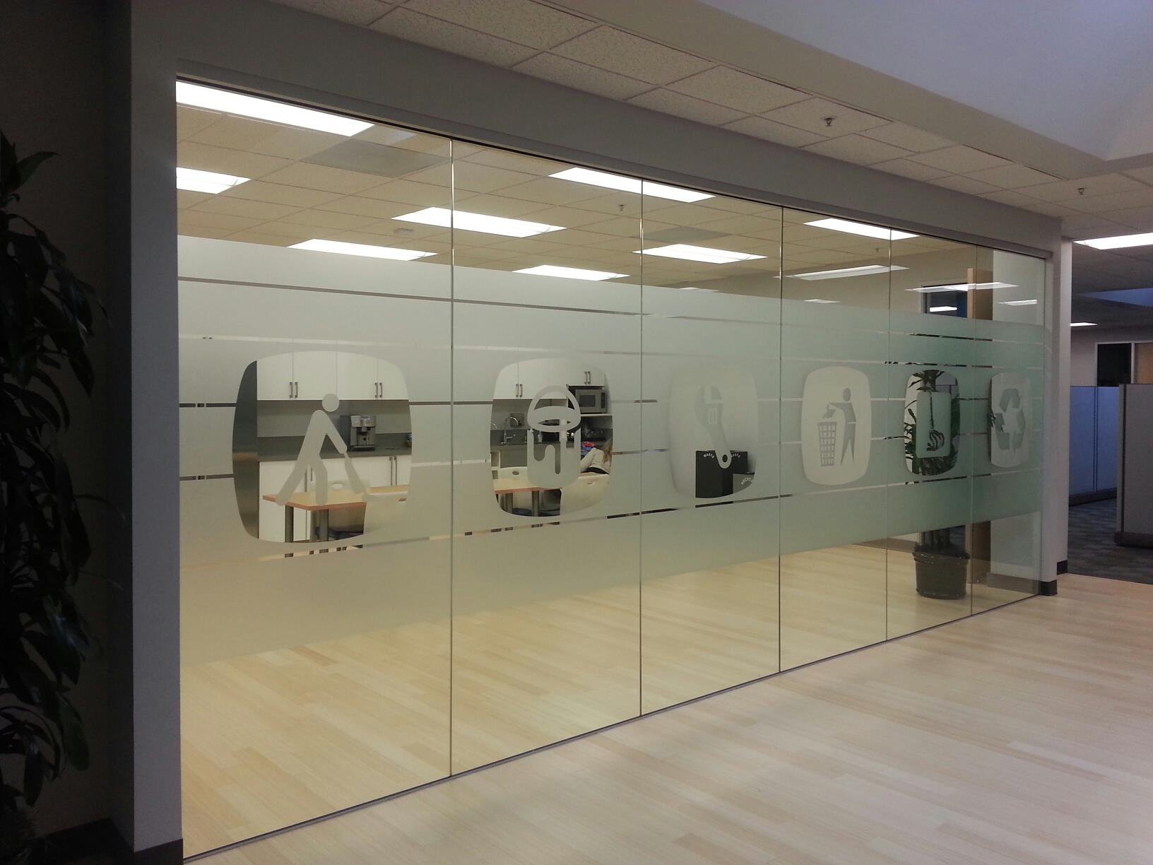 Full-height frosted privacy window film installation across glass conference rooms