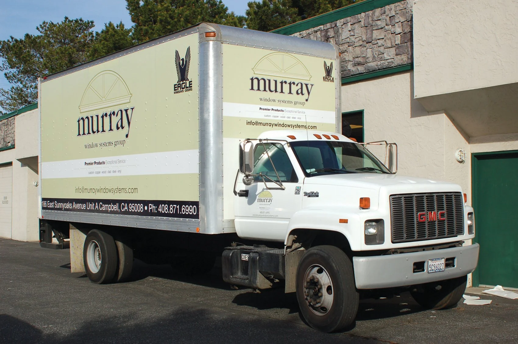 Box truck with full commercial wrap showcasing large-format fleet graphics and rear door branding for maximum visibility.