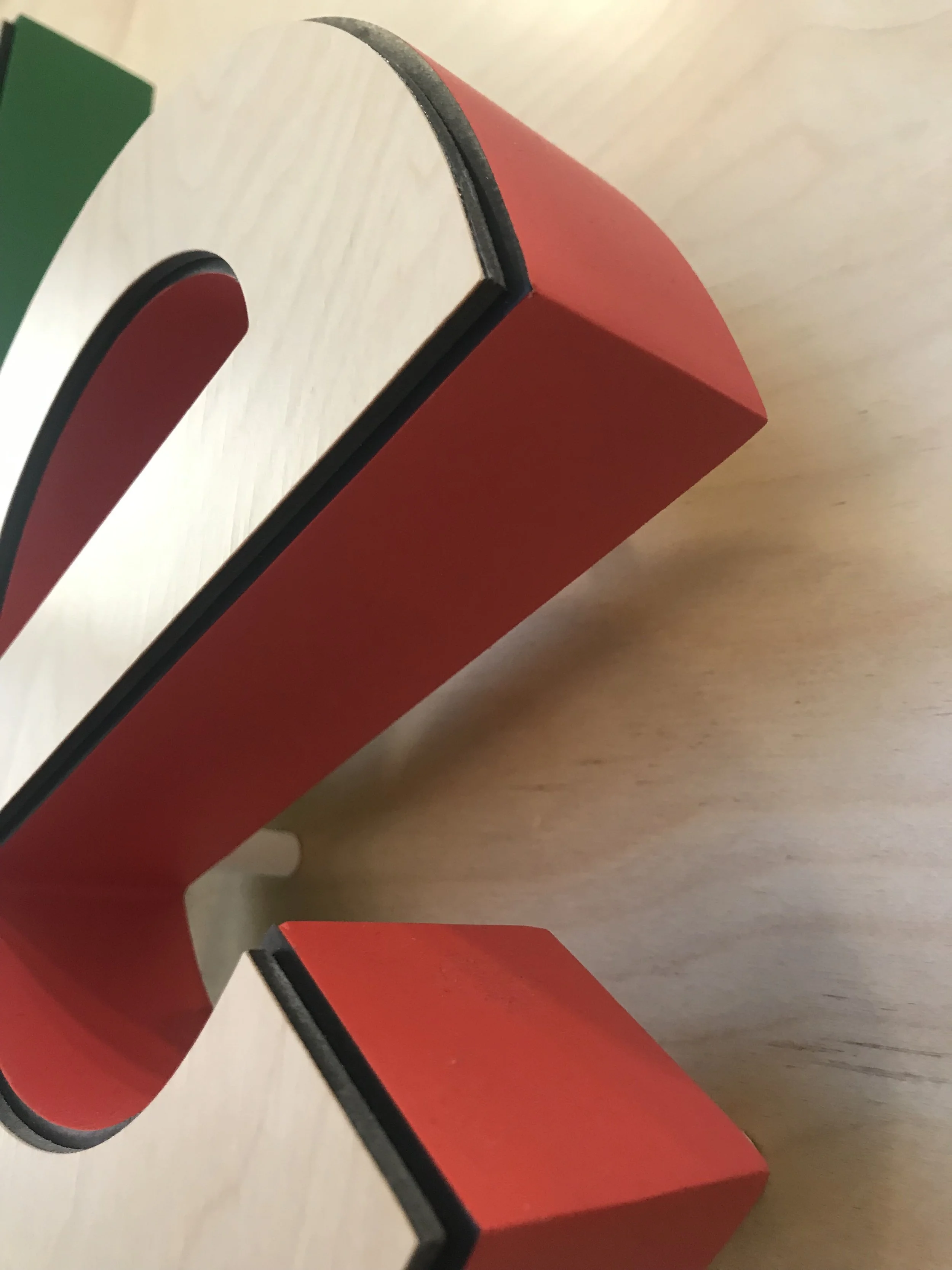 Close-up of dimensional Google letter with birch wood veneer face and painted acrylic sides, illustrating material quality, thickness, and premium custom signage fabrication.