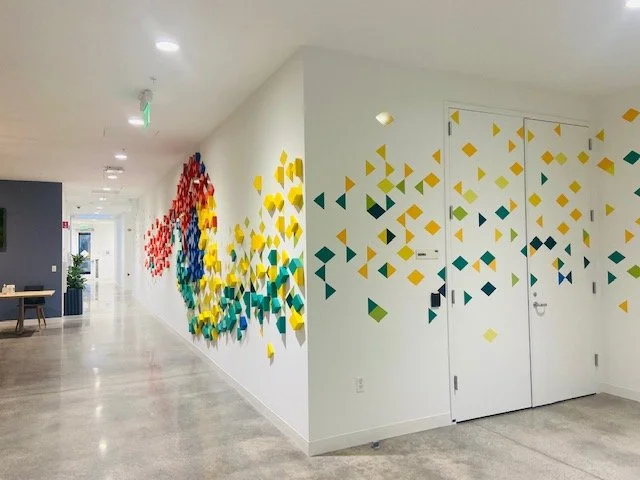 Large-scale environmental graphic designed to transform a blank corridor into a vibrant, branded experience.