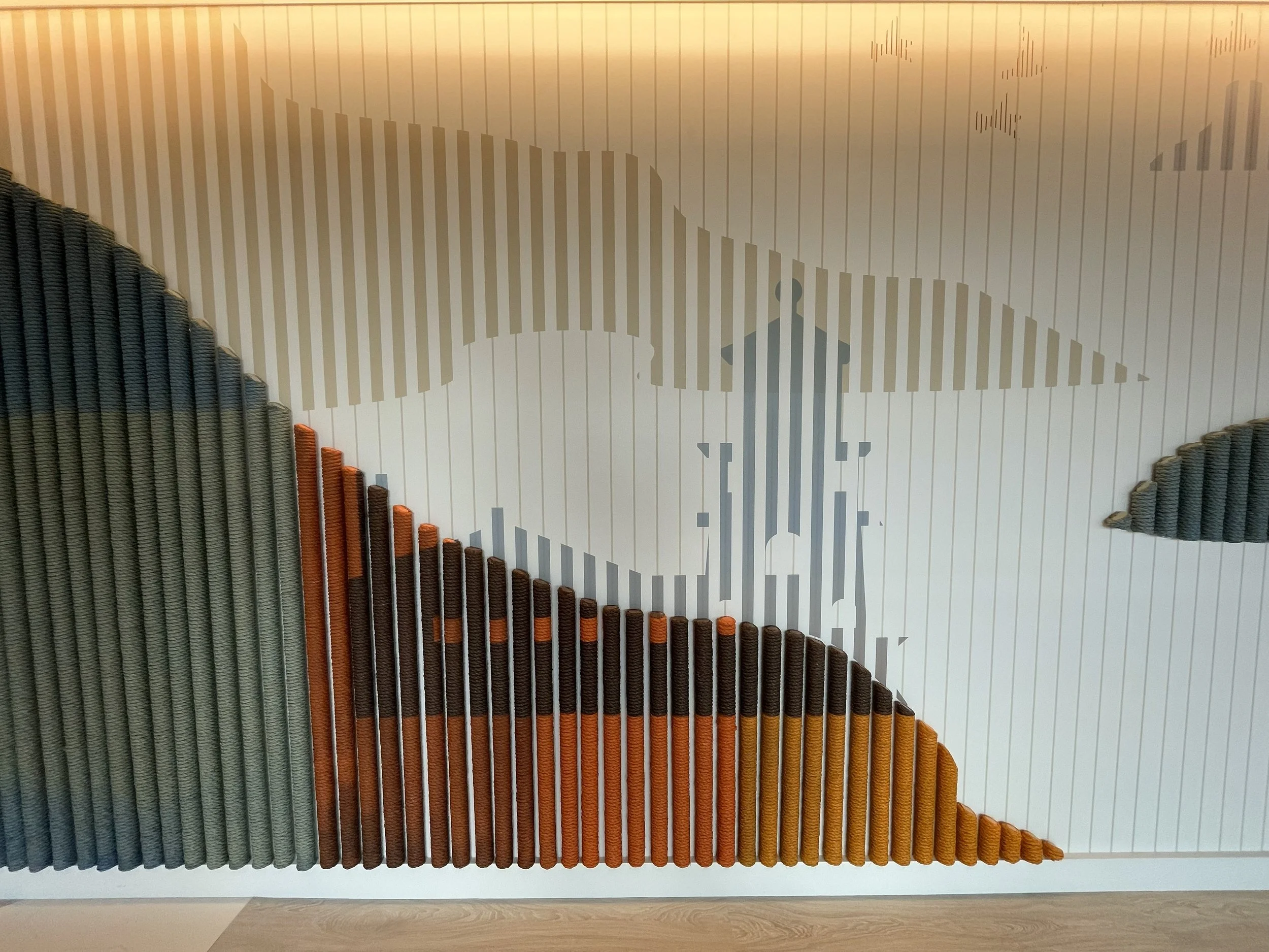 Close-up view of textured environmental wallcovering with vertical dimensional rope elements forming a custom feature wall at KPMG office in Minneapolis, Minnesota.