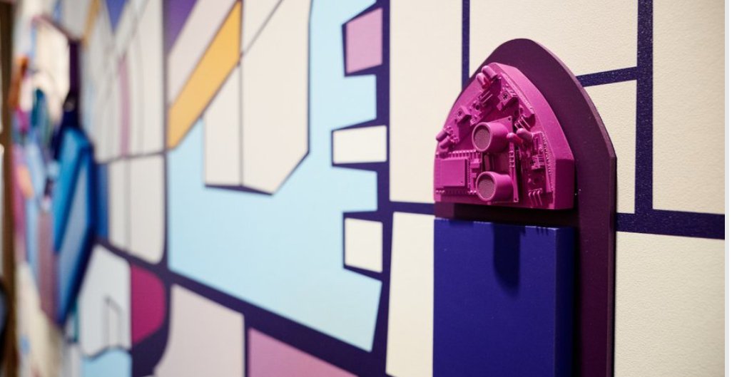 Close-up of custom dimensional 3D architectural element mounted over environmental graphic wallcovering at the KPMG San Jose office.