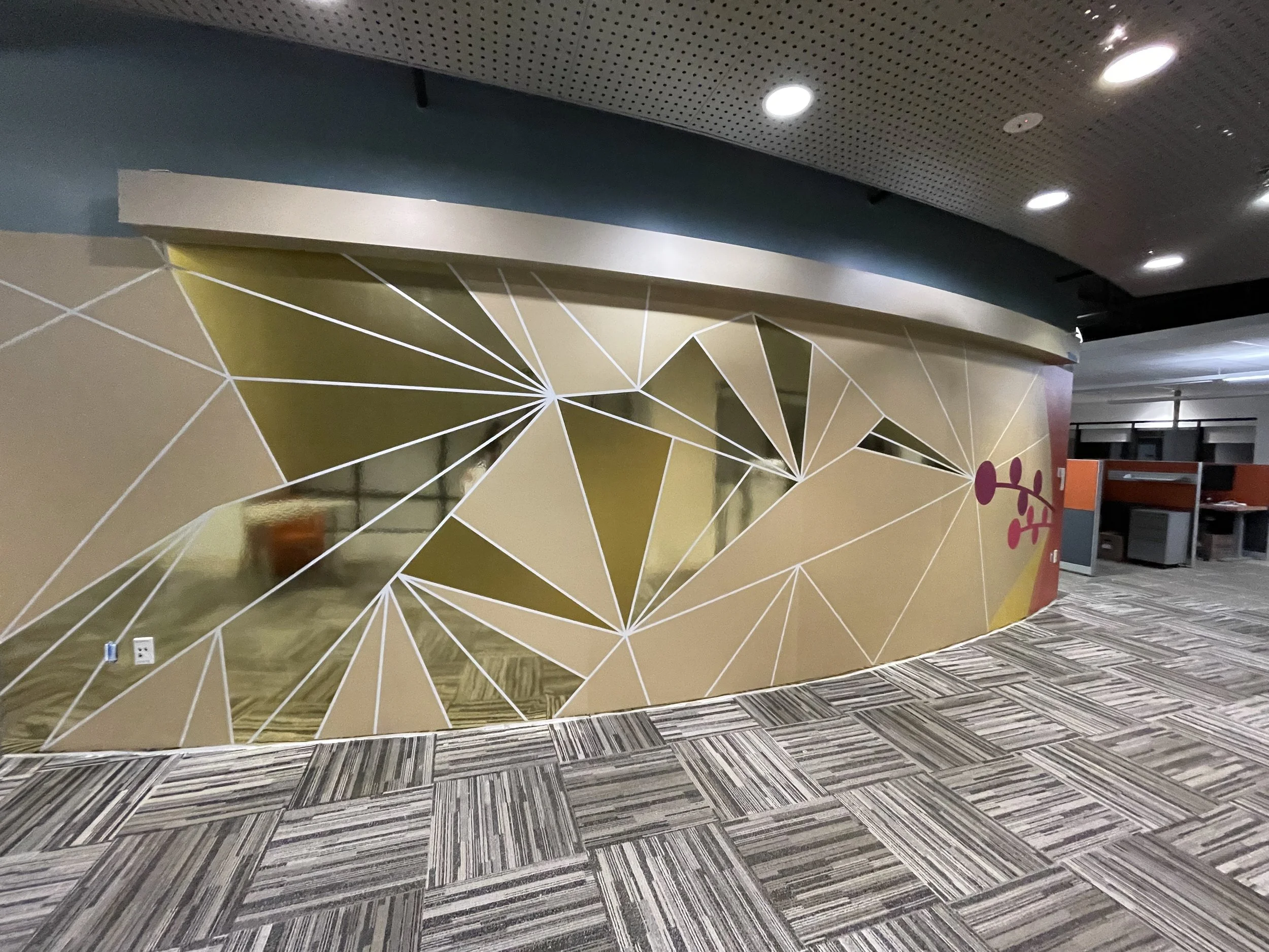 Curved geometric metallic wallcovering installation with faceted gold graphic design at Amazon SJC3 office, fabricated and installed by JP Digital in Cupertino, California.