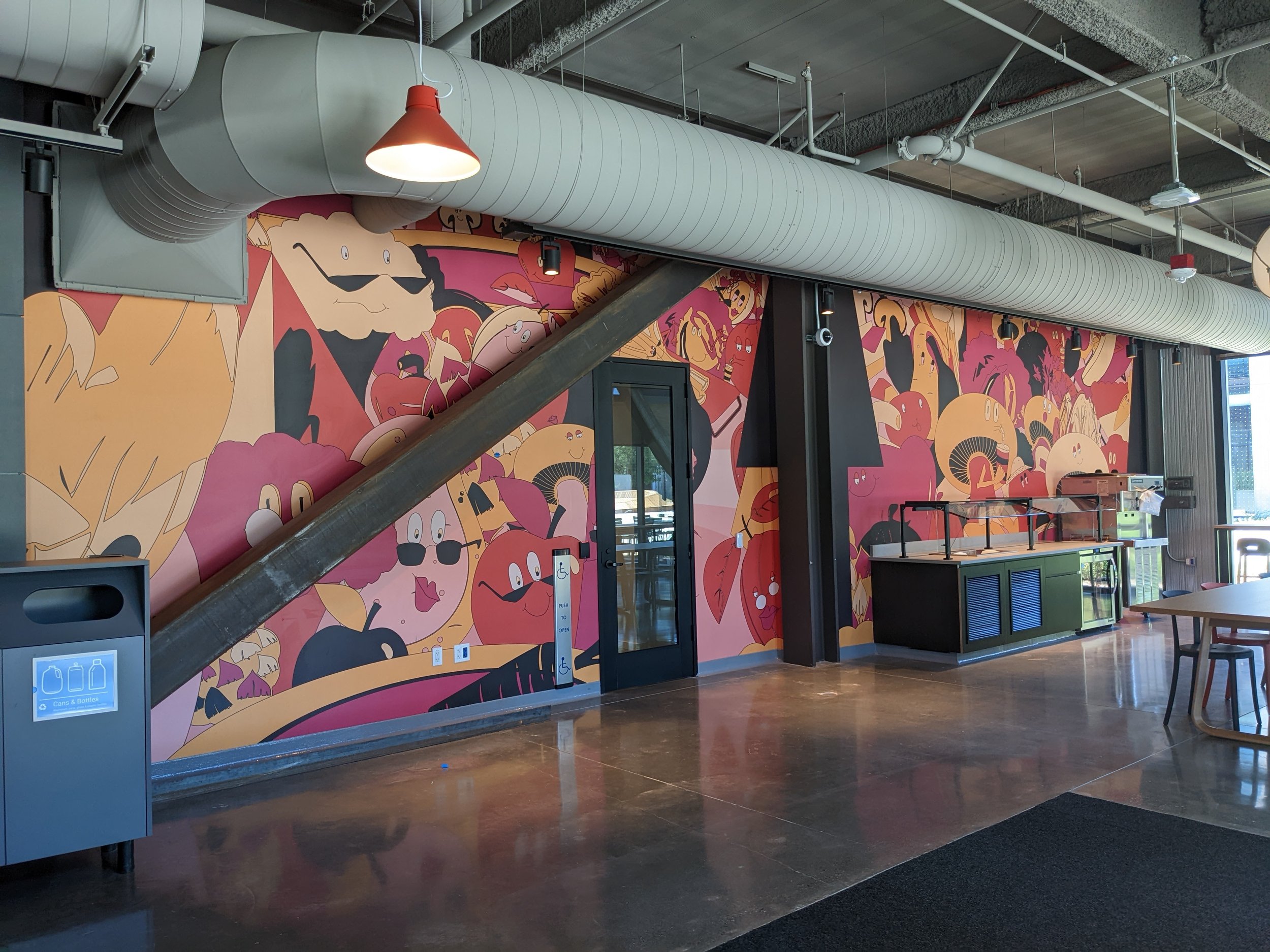 Custom food-themed illustrated wall mural installation in a commercial restaurant interior featuring large-scale environmental graphics and branded wallcovering