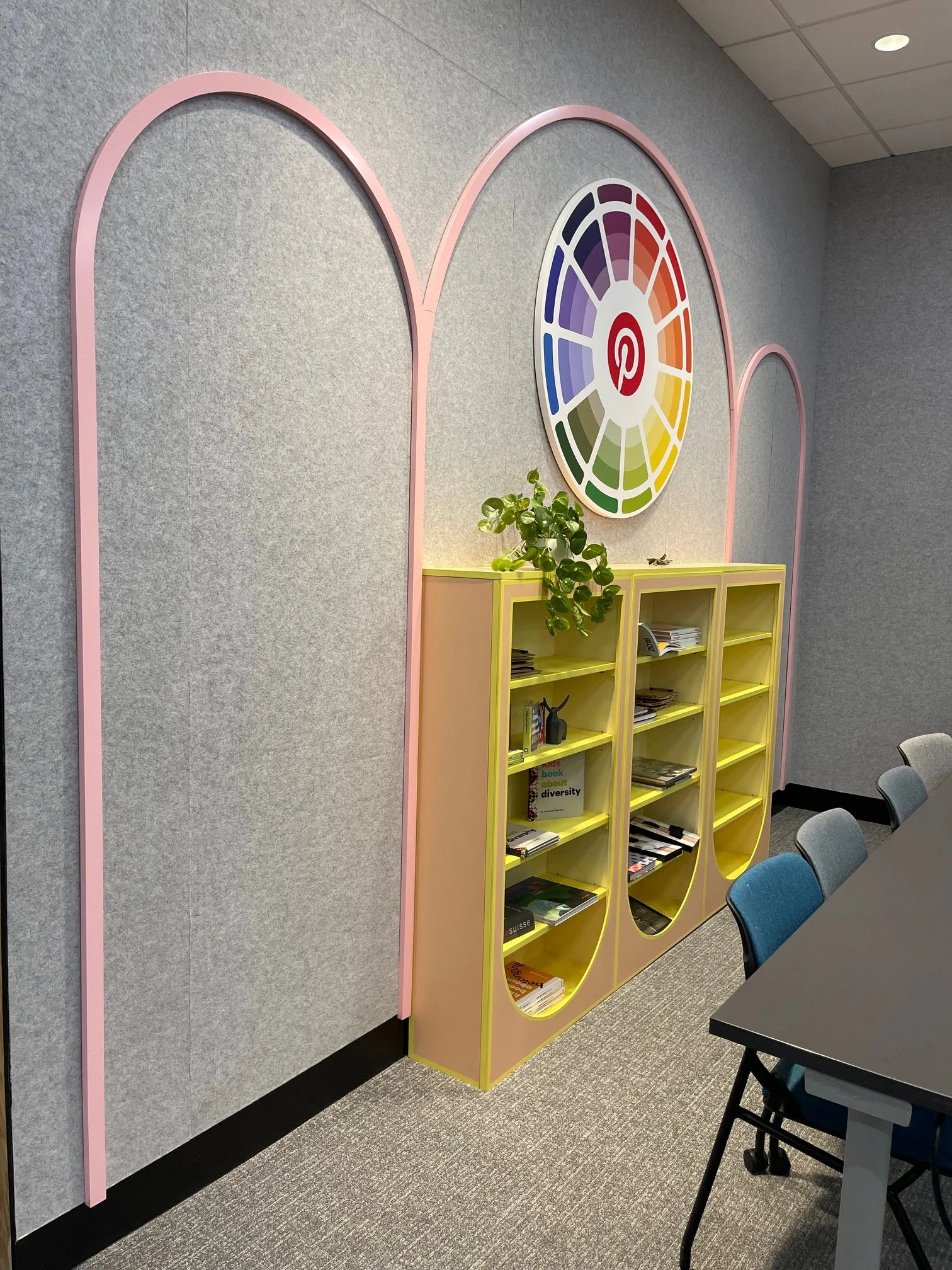 Side view of Pinterest San Francisco feature wall with arched environmental graphics and custom yellow storage cabinets, installed by JP Digital.