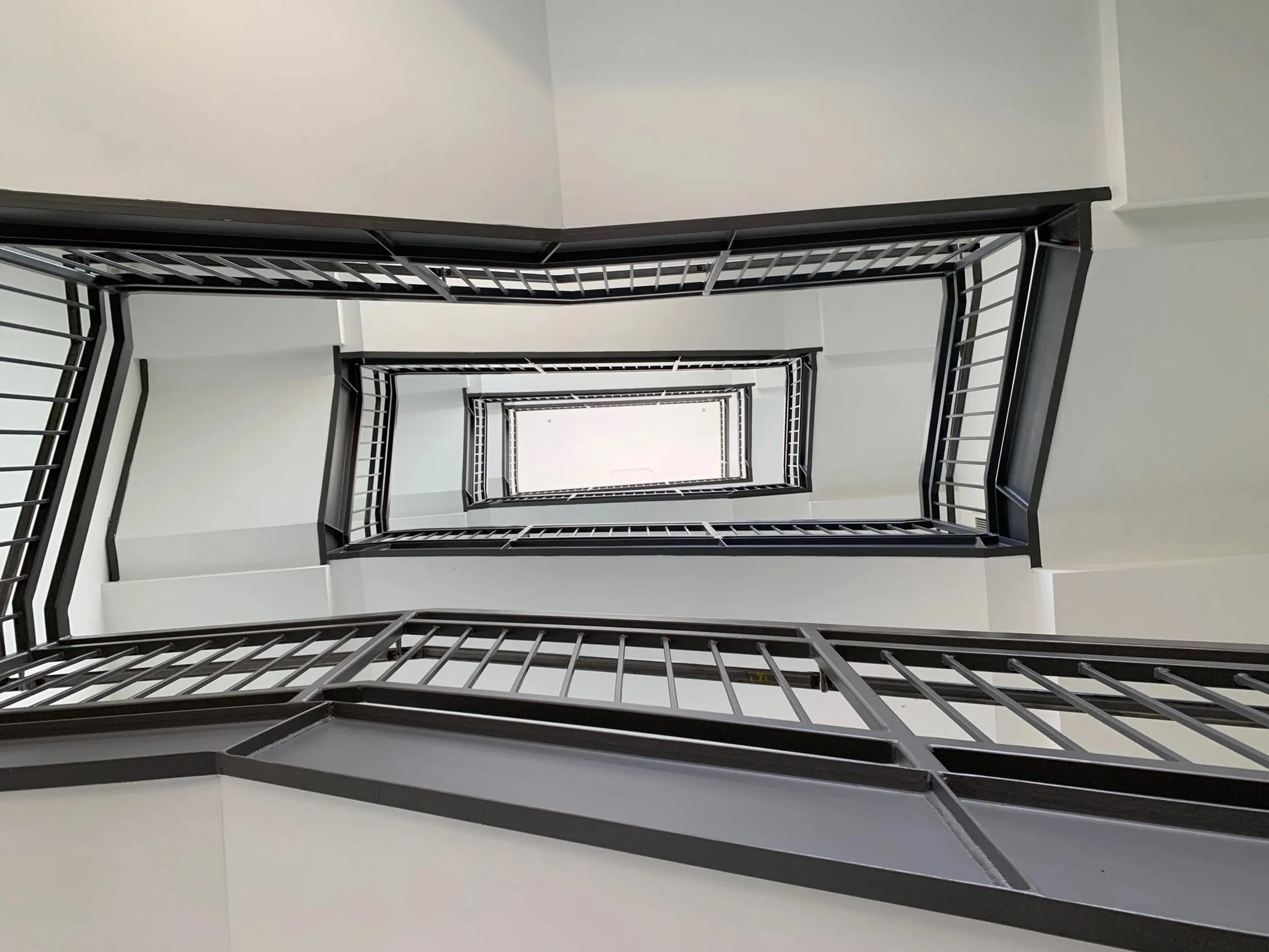 original staircase ceiling before customwallcovering installation on stairwell ceiling at Google Santa Cruz, featuring large-format environmental graphics designed to enhance vertical architectural spaces.