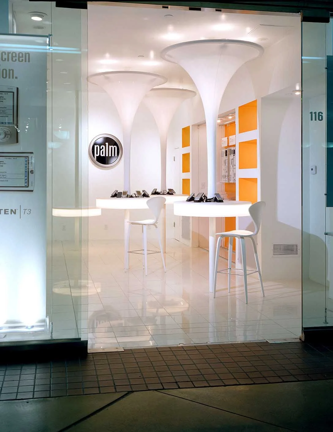 Custom showroom-style exhibit space featuring branded walls and product display installations