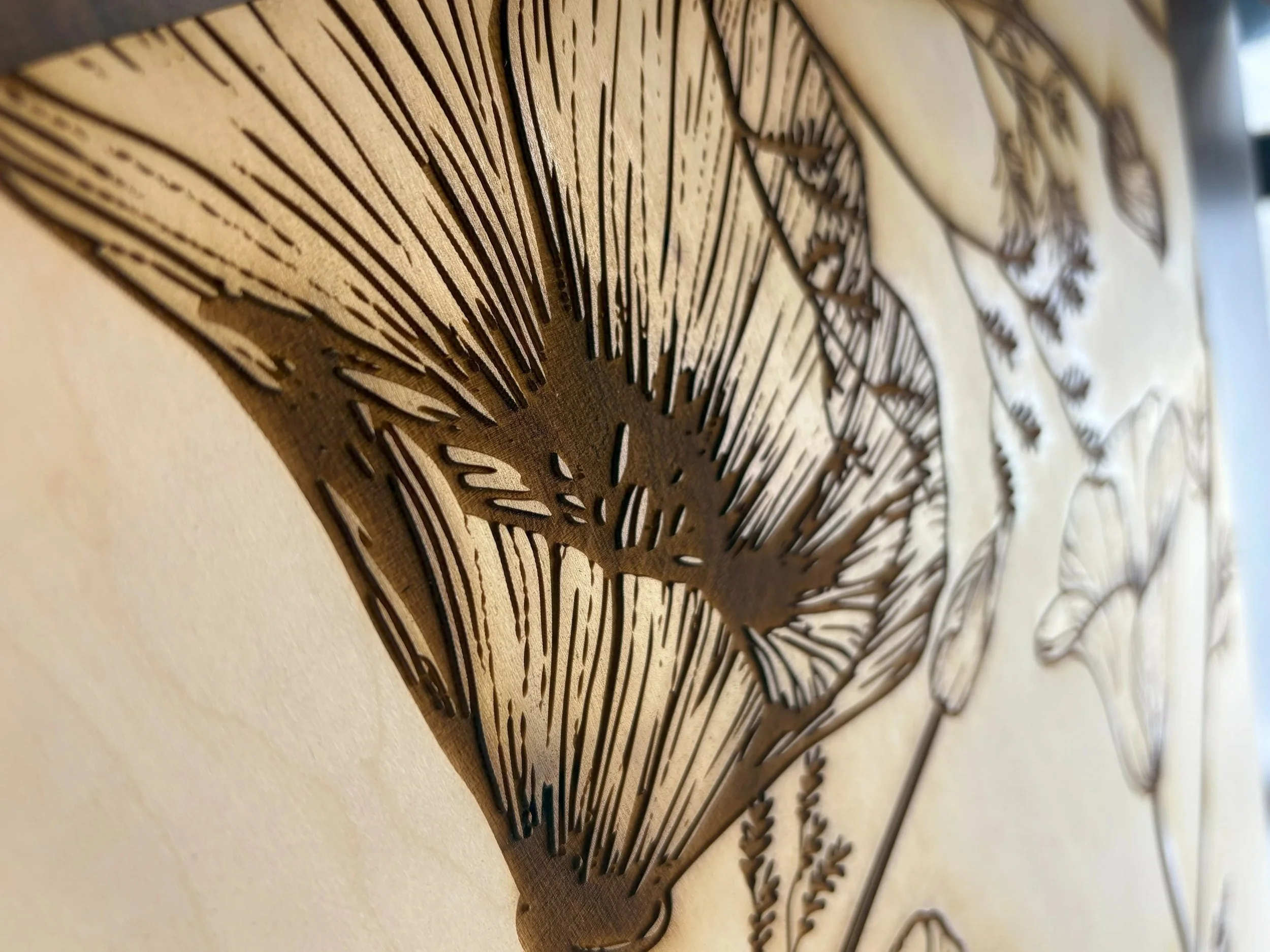 Close-up of laser-cut dimensional wood floral detail from custom architectural feature wall at the KPMG San Jose office.