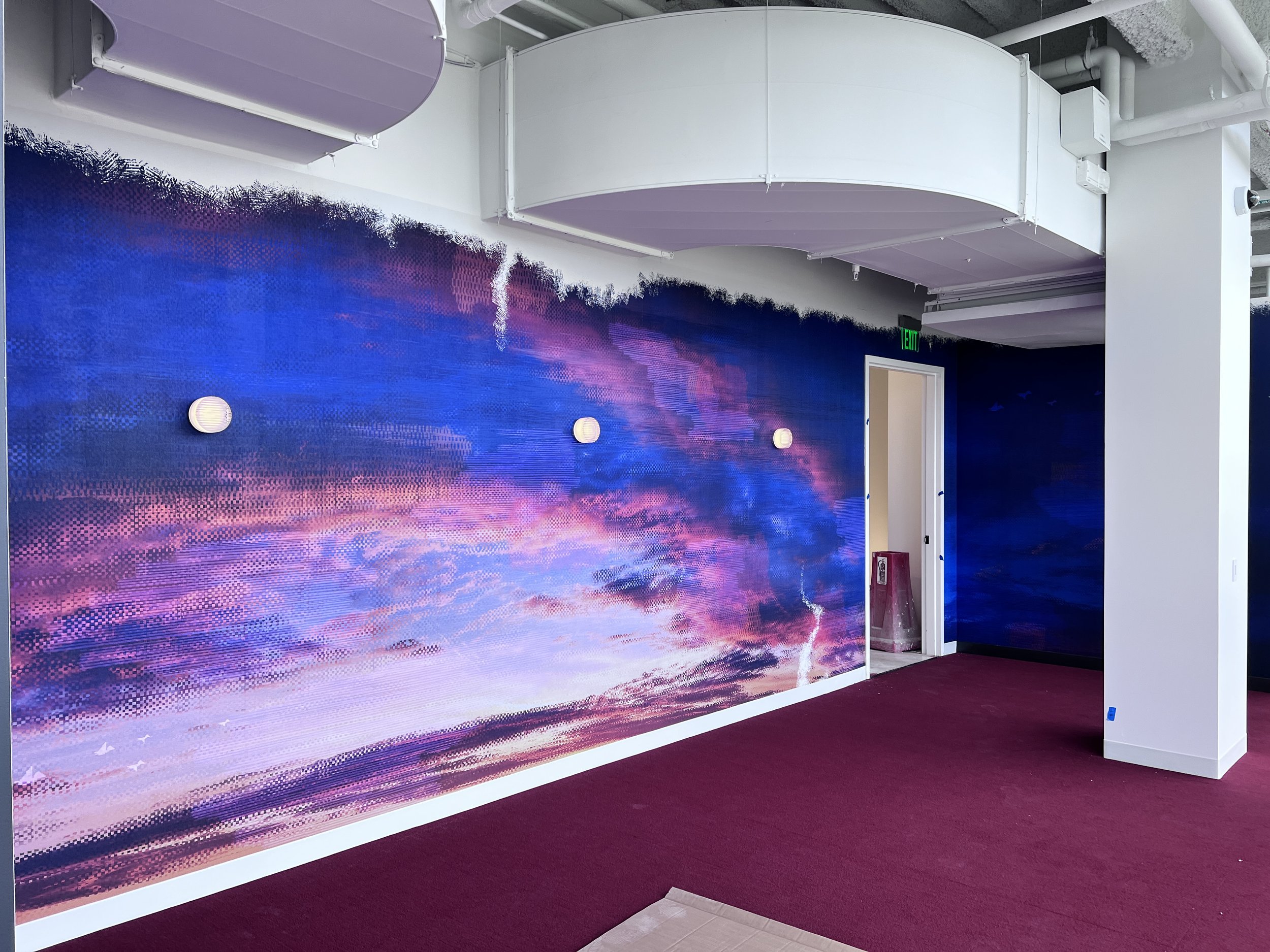 Vibrant abstract color mural wallcovering installed in a corridor for high-impact environmental graphics.