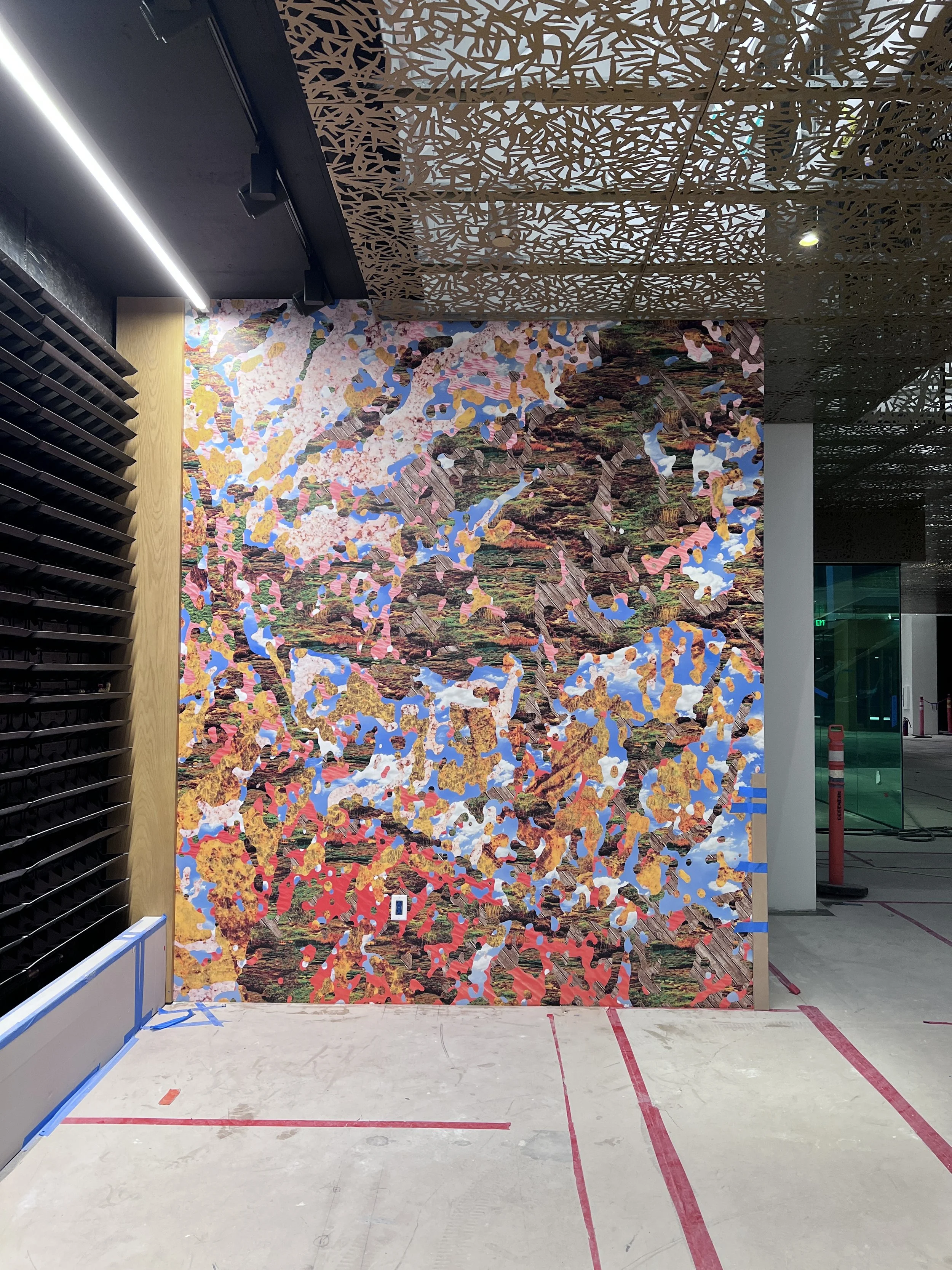 Full-height multicolor abstract wallcovering installed in a corridor for high-impact commercial branding.