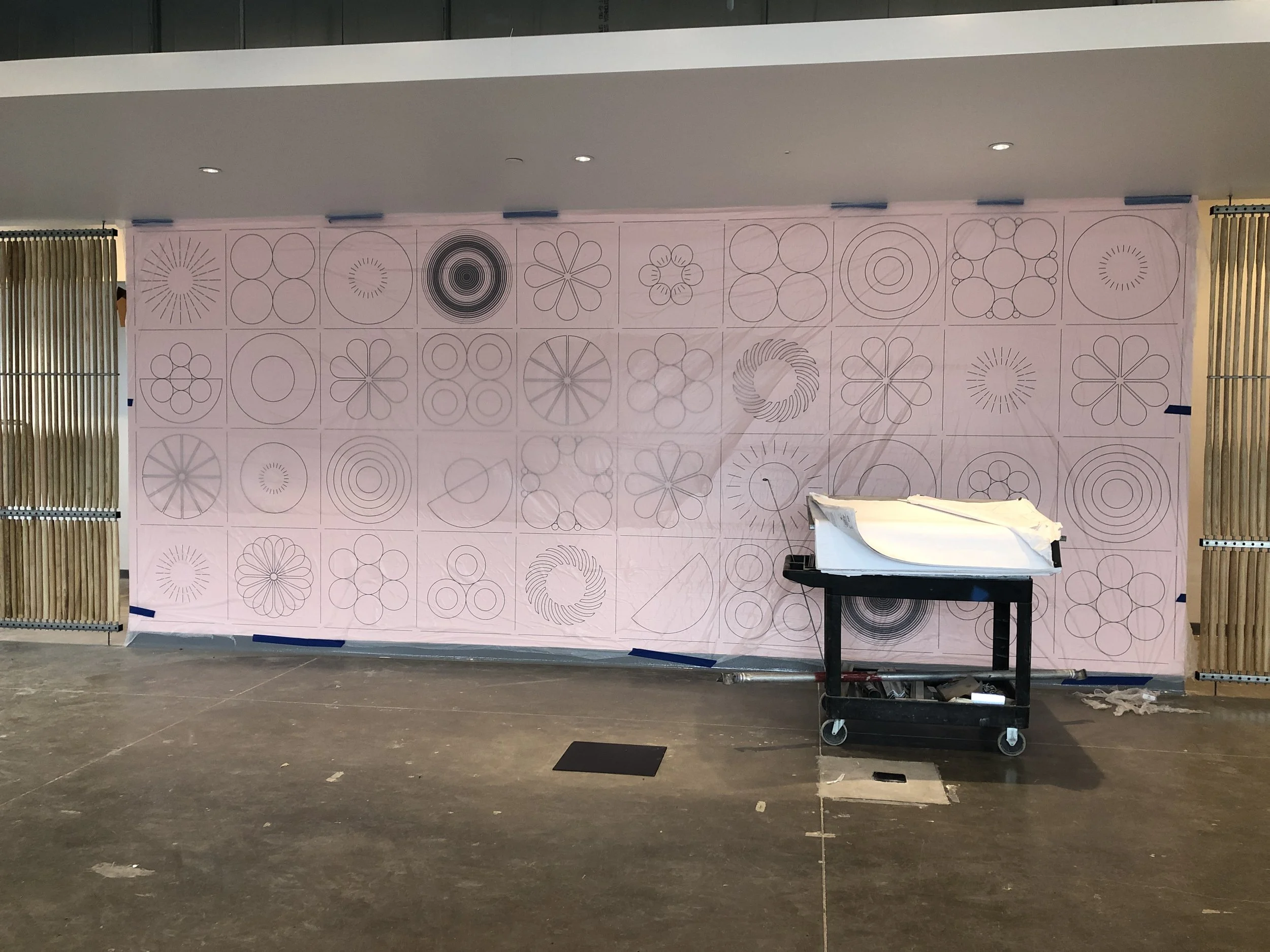 Full-scale wallcovering layout test installed on-site to verify panel alignment and positioning for custom commercial environmental graphics in the Humboldt  project