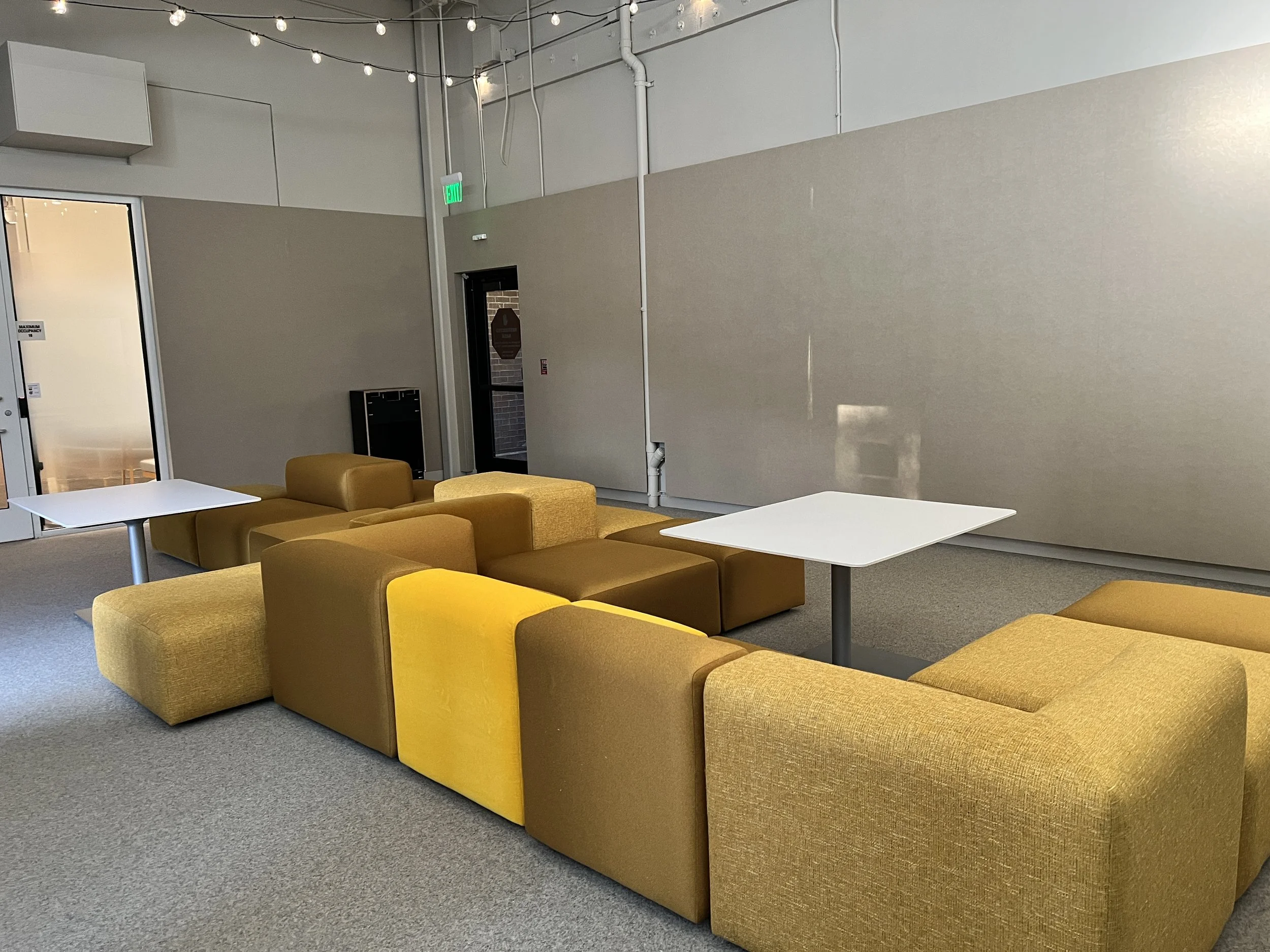 Acoustic wall panels installed in workplace lounge to reduce noise and improve comfort
