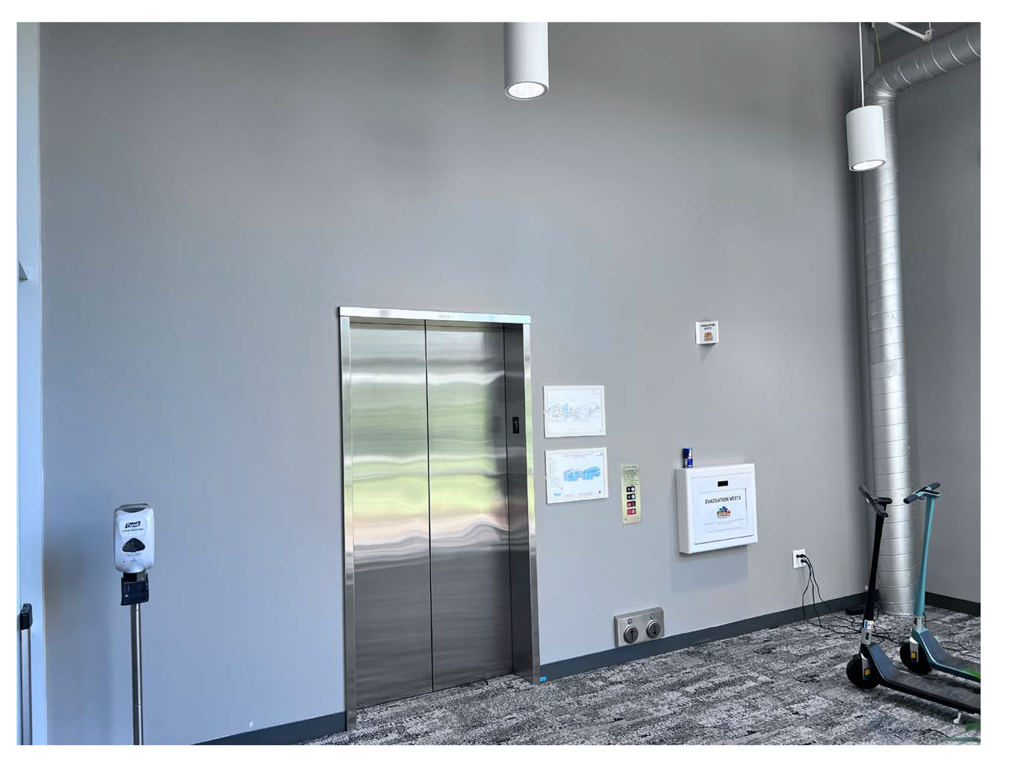 Elevator area with blank gray wall prior to environmental graphics installation in the Amphitheatre.