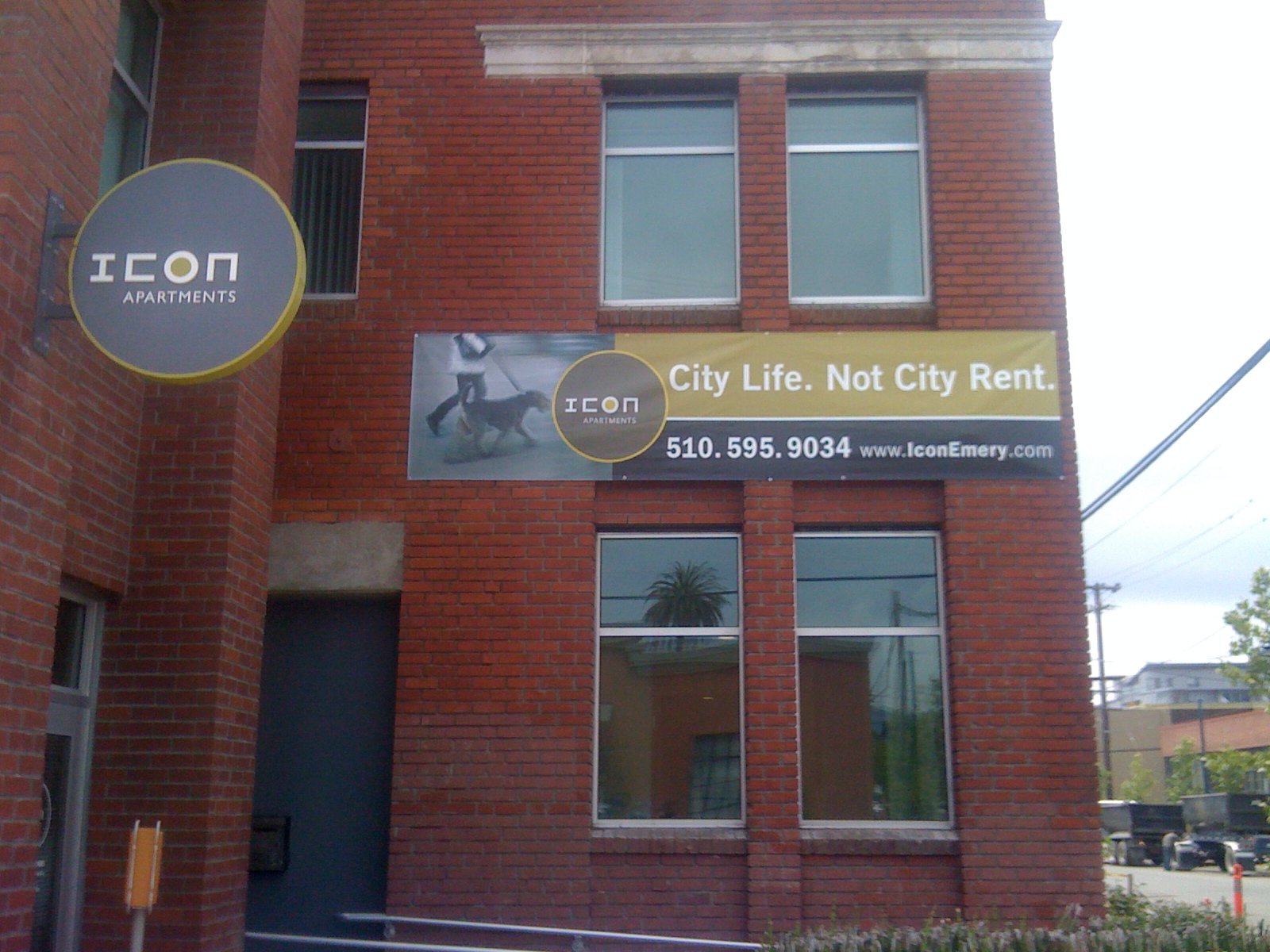 Exterior building identification signage displaying business information on commercial property entrance
