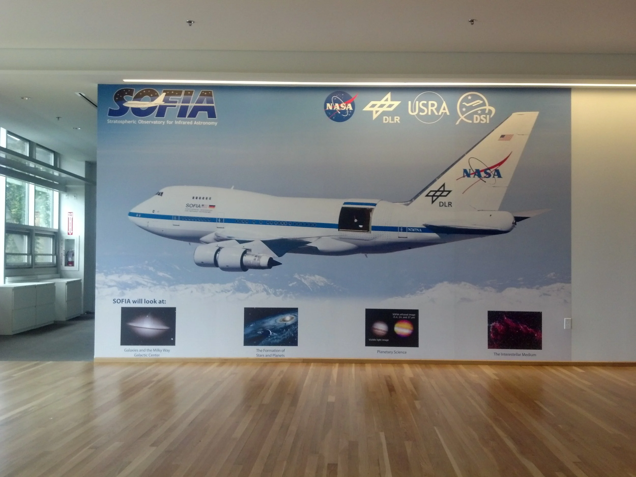 Aviation history wall mural with aircraft graphics installed as a large-format environmental display.